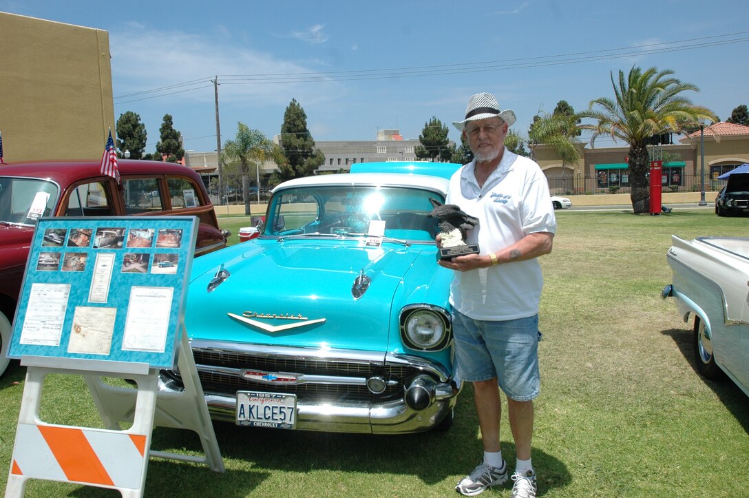 Jim Casey of the South Bay Cruisers car club poses with his car, a restored 1957 Chevy, after winning the General's Choice at the 7th Annual Auto hobby Car and Motorcycle Show here, July 31.