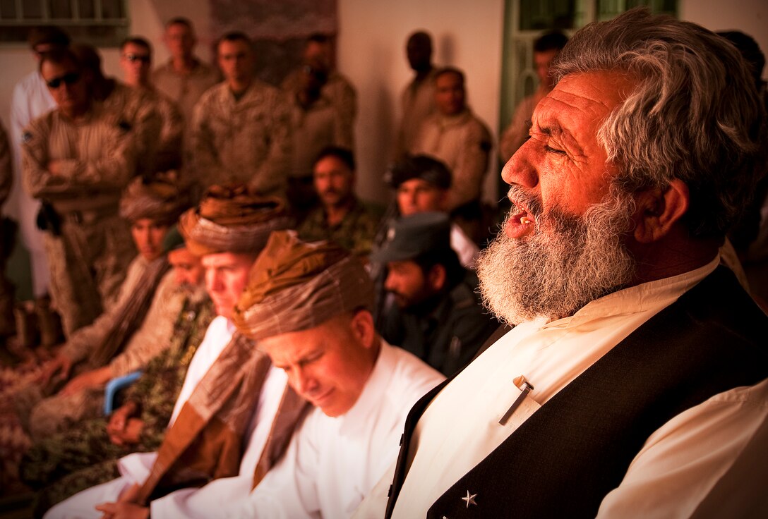 Haji Abdul Manaf, Nawa District governor, addresses the crowd at a lunch event honoring the work of 1st Battalion, 3rd Marine Regiment, and welcoming their replacement, 3rd Battalion, 3rd Marine Regiment, at Patrol Base Jaker June 3. At the event, Manaf called all the people of Nawa Marines in a nod to the close relationship that has developed between Nawa’s citizens and the Marines in the area.