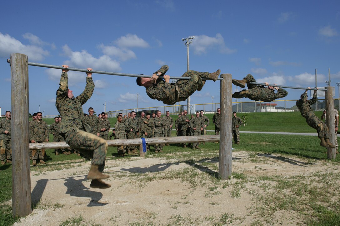 U.S. Marines with Battalion Landing Team, 2nd Battalion, 7th Marines, 31st Marine Expeditionary Unit, maneuver over the first bar in an obstacle course during a squad competition, June 1. (U.S. Marine Corps photo by Lance Cpl. Kelsey J. Green/Released)