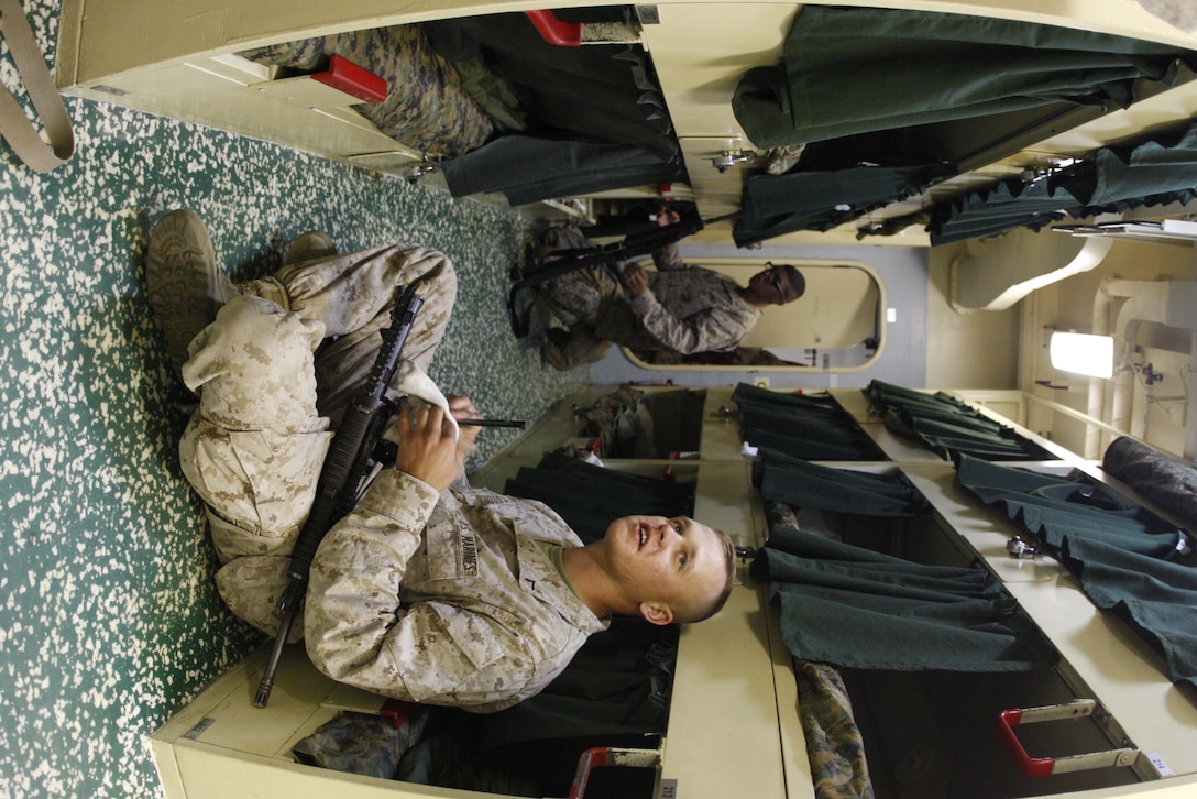 Private first class Chris Storm, a rifleman with Company C, 1st Battalion, 7th Marine Regiment, cleans his weapon June 1 in the company’s berthing area aboard the USS Bonhomme Richard. The battalion spent their first week aboard ship preparing for their upcoming deployment with the 31st Marine Expeditionary Unit.