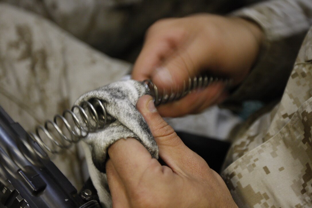 Private first class Chris Storm, a rifleman with Company C, 1st Battalion, 7th Marine Regiment, performs weapons maintenance June 1 in the company’s berthing area aboard the USS Bonhomme Richard. The unit is slated to be the battalion landing team for the 31st Marine Expeditionary Unit.