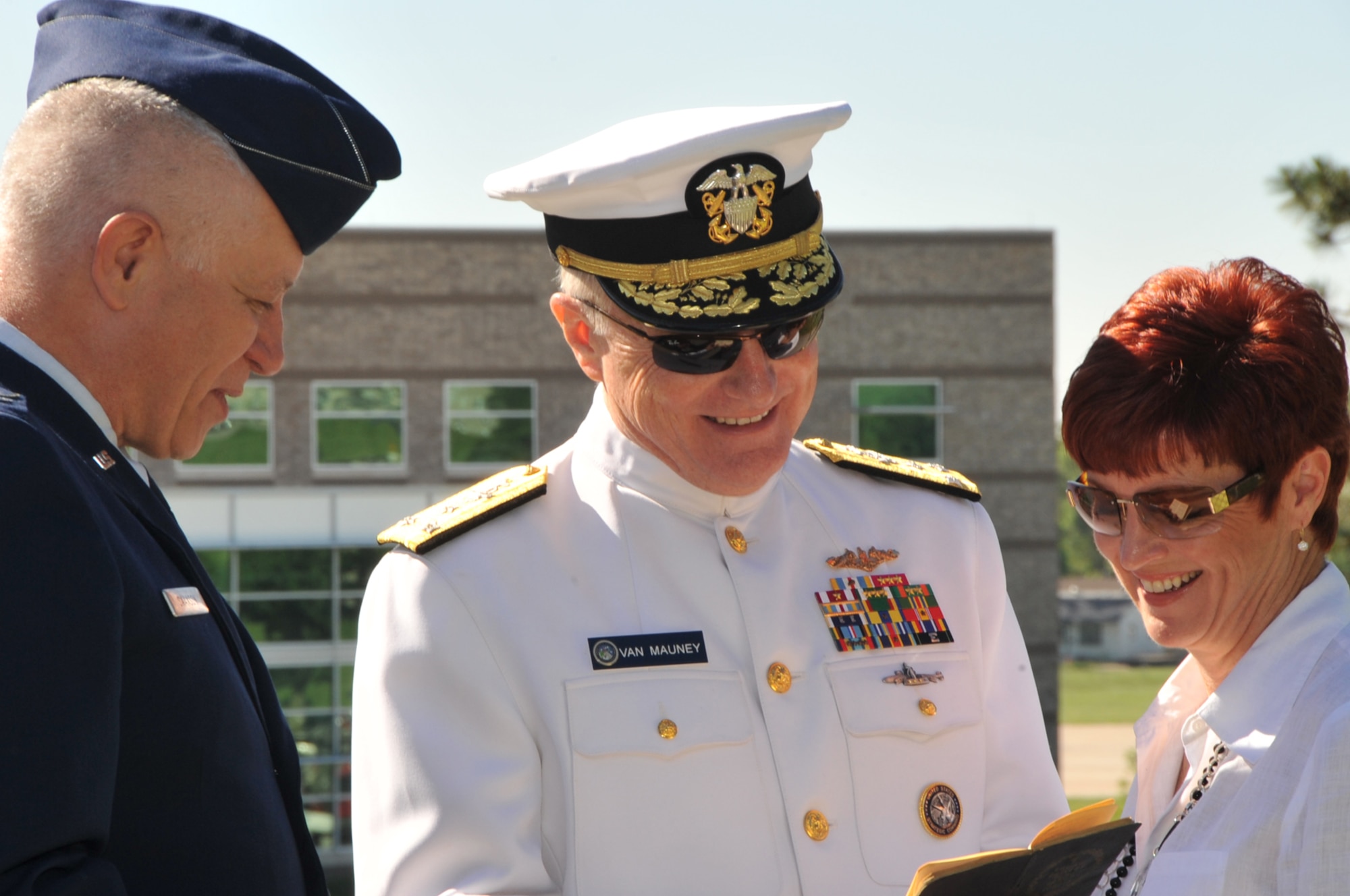 OFFUTT AIR FORCE BASE, Neb. -- With the Air Force Weather Agency building in the background, Adm. Carl V. Mauney, deputy commander of U.S. Strategic Command and his wife Debby, meet with Chaplain (Col.) Carl J. Swanson, after Offutt's Memorial Day ceremony at the base cemetery here May 31. During the ceremony, Colonel Swanson read a prayer to honor every servicemember who has made the ultimate sacrifice. More than 100 people attended the annual memorial service. U.S. Air Force Photo by D.P. Heard