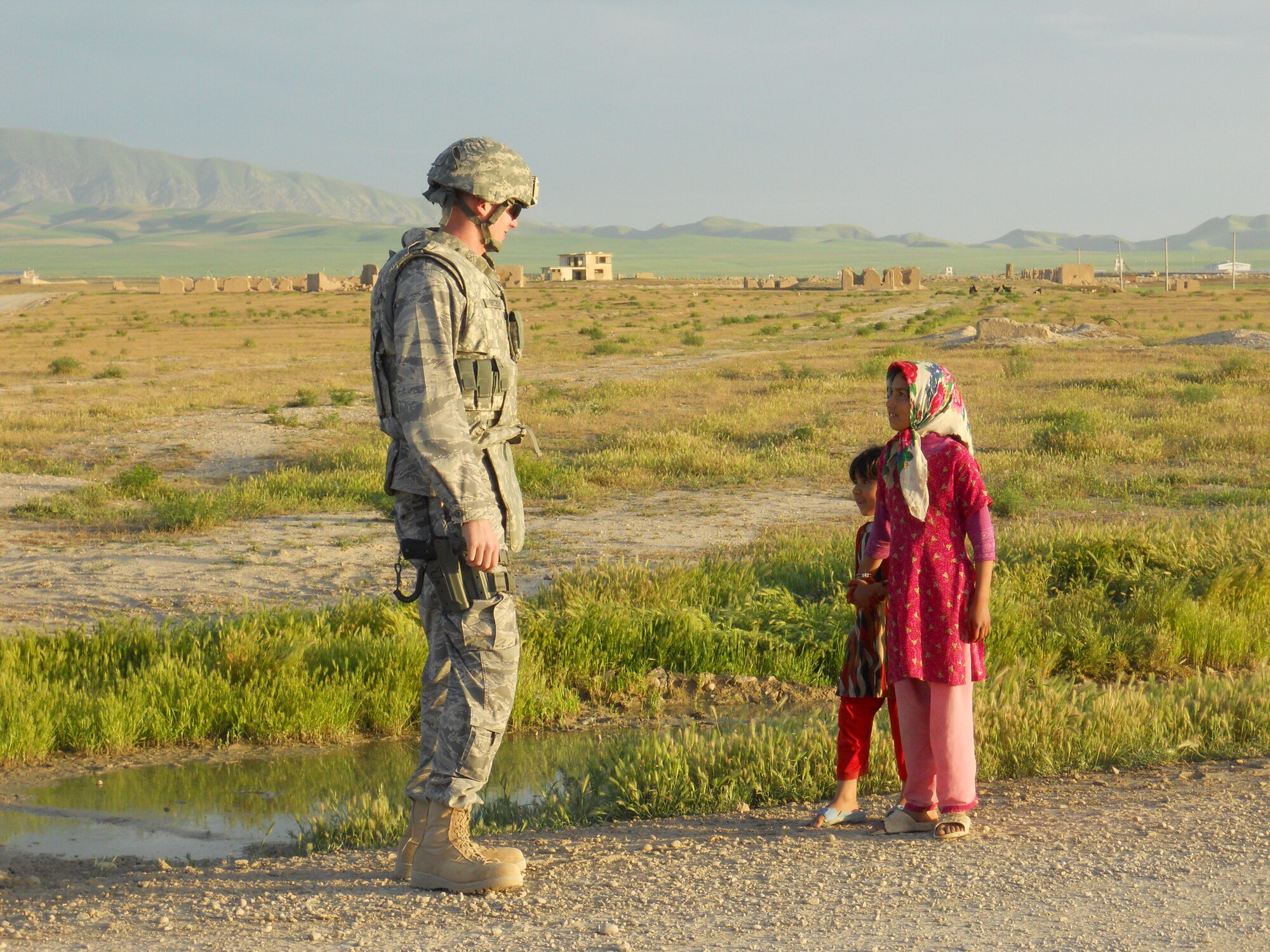 1st Lt. Art Dietrich greets two local children April 21, 2010 while deployed to Afghanistan.  Lieutenant Dietrich  is currently assigned on a reconstruction team to help rebuild infrastructure in Afghanistan. He is assigned to the 354th Civil Engineer Squadron, Eielson Air Force Base, Alaska. (Courtesy photo)
          