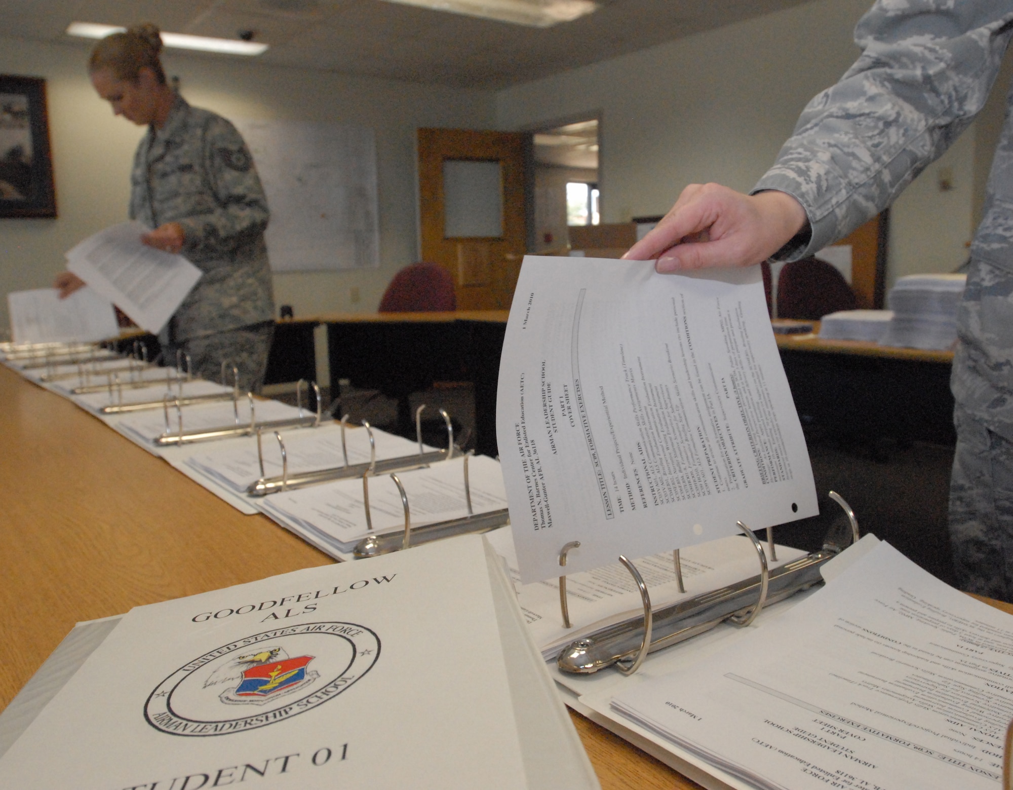 Tech. Sgt. April Miller, an instructor with the Goodfellow AFB Airman Leadership School, and Tech.  Sgt. Jasmine Chavez, an instructor with the Dyess AFB Airman Leadership School, put together student books for the start of the first class of the Goodfellow ALS, June 1.  Tech. Sgt. April Miller and Tech. Sgt Chavez are preparing for the first ALS class at Goodfellow AFB, TX starting June 2. (U.S. Air Force photo/ Master Sgt. Randy Mallard)