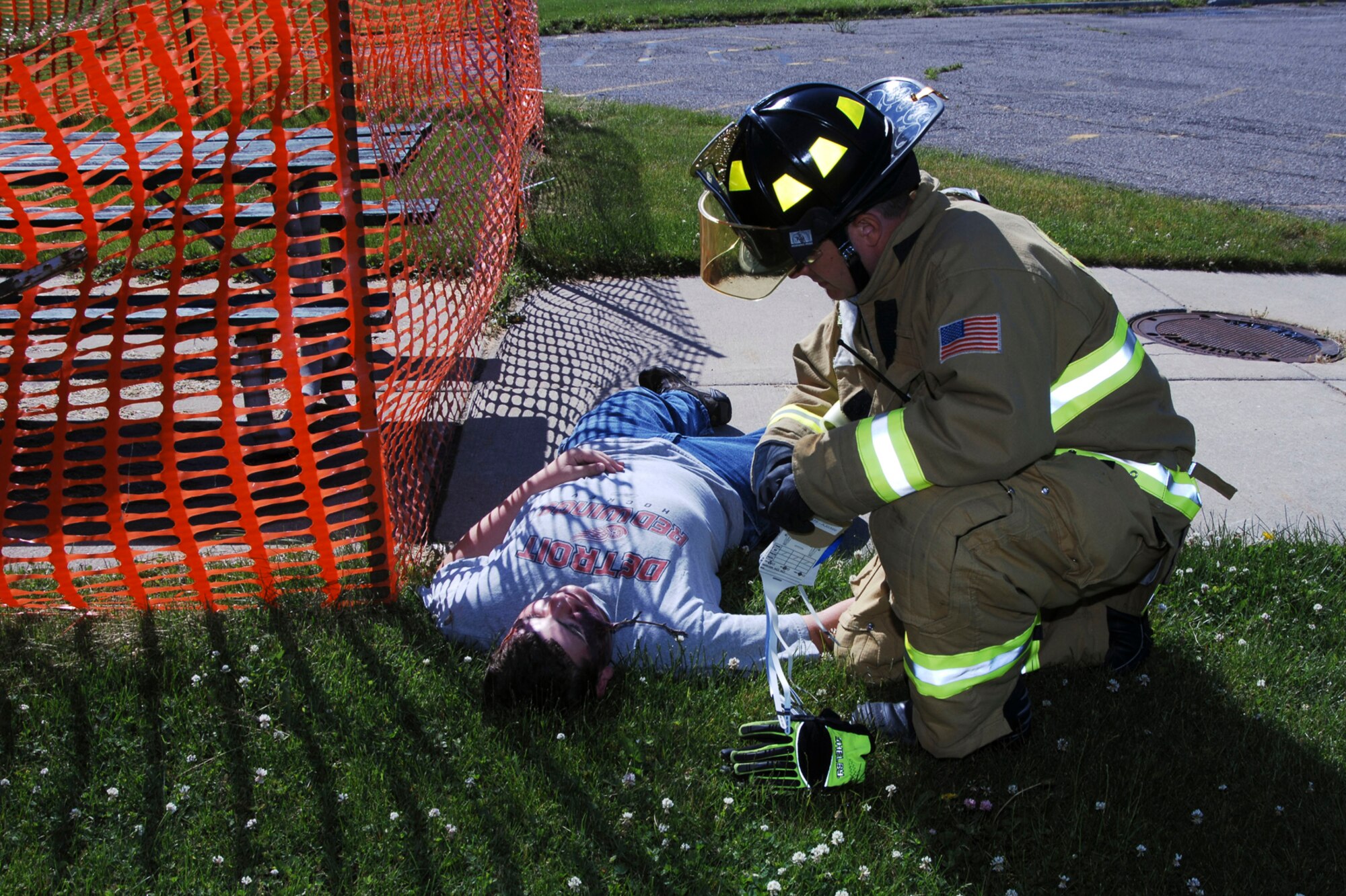 Selfridge ANG Base Firefighter, SSgt. Jeffrey Yelencich, aids a simulated casualty portrayed by Civil Air Patrol member Jake Healy during a tornado response exercise held by the 127th Wing at Selfridge Air National Guard Base on June 1. (USAF Photo by SSgt. Rachel Barton, released).