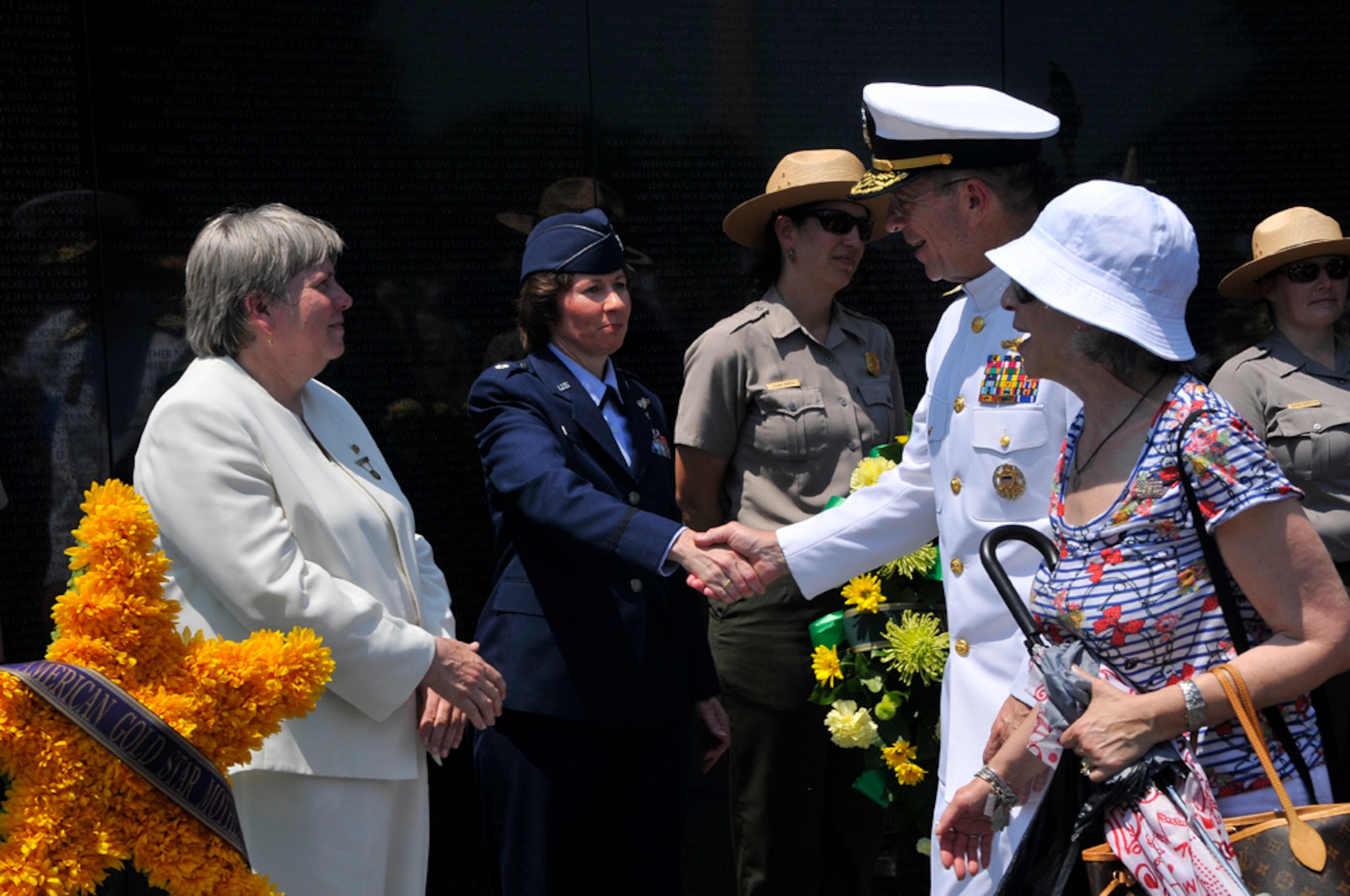 Lt. Col. Mary Carlisle, 579th Medical Group, shakes hands with U.S. Navy Admiral Mike Mullen, Chairman of the Joint Chiefs of Staff, following her speech at the Vietnam Memorial on Memorial Day. Colonel Carlisle has held several clinical, educational and leadership positions at various assignments including medical surgical, critical care, ambulatory surgery and emergency services. She was deployed as a critical care nurse with the Expeditionary Medical Support unit to Masirah Air Base, Oman, to support Operation Enduring Freedom in 2001 and 2002; and to the Air Force theater hospital at Balad Air Base, Iraq, to support Operation Iraqi Freedom in 2007. She sought care for post-traumatic stress disorder after returning from Iraq and was profiled in the Real Warriors Campaign as a person seeking healing for the mental and emotional costs of war. (U.S. Air Force photo by Marilyn Holliday)