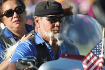 HONOLULU - A motorcycle rider, his wife and dog arrive at the National Cemetery of the Pacific in the Pu'owaina Crater, also known as the Punchbowl for a Vietnam Veteran and wreath laying ceremony on May 30 in Honolulu, Hawaii.  (U.S.  Air Force photo/Tech Sgt. Cohen A. Young)