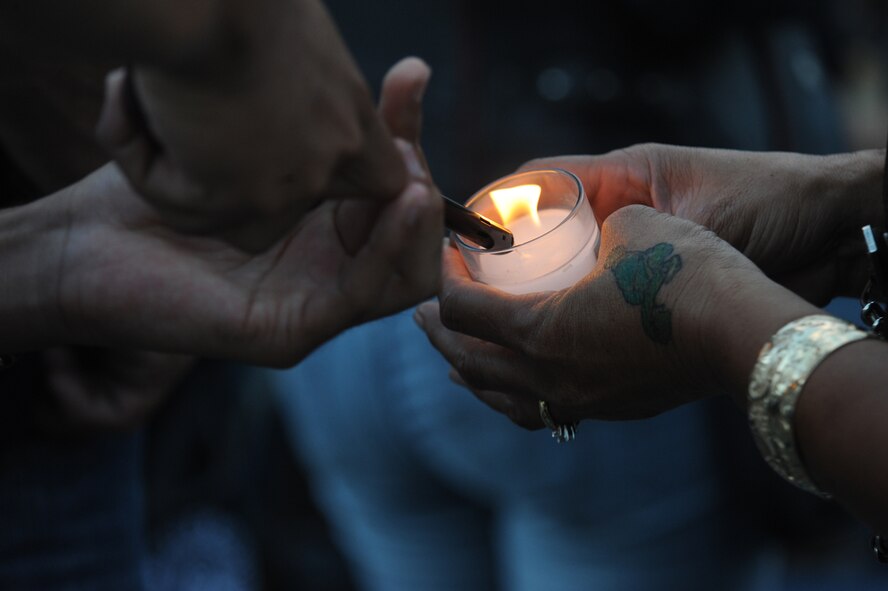 HONOLULU - A woman has her candle lit during a candle vigil at the National Cemetery of the Pacific in the Pu'owaina Crater, also known as the Punchbowl during a Vietnam Veteran and wreath laying ceremony on May 30 in Honolulu, Hawaii.  (U.S.  Air Force photo/Tech Sgt. Cohen A. Young)