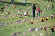 HONOLULU - A Hawaiian family gathers around the gravesite of a family member at the National Cemetery of the Pacific in the Pu'owaina Crater, also known as the Punchbowl on May 30 in Honolulu, Hawaii.  (U.S.  Air Force photo/Tech Sgt. Cohen A. Young)