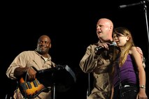HONOLULU - U. S. Air Force Band of the Pacific - Hawaii members, also known as "Hana Hou" enlist the help of a little girl from the audience to sing part of the chorus with them in front of more than 400 onlookers during a Military Band Melee event at Ft DeRussy Park in Honolulu, Hawaii on May 29 as part of Military Appreciation Month and a prelude to Memorial Day events. The U.S. Army's 25th Infantry Division Band, the U. S. Navy Pacific Fleet Band, the Marine Corps Forces Pacific Band, the U.S. Air Force of the Band of the Pacific-Hawaii and the U.S. Coast Guard were all represented at the free concert.  (U.S.  Air Force photo/Tech Sgt. Cohen A. Young)