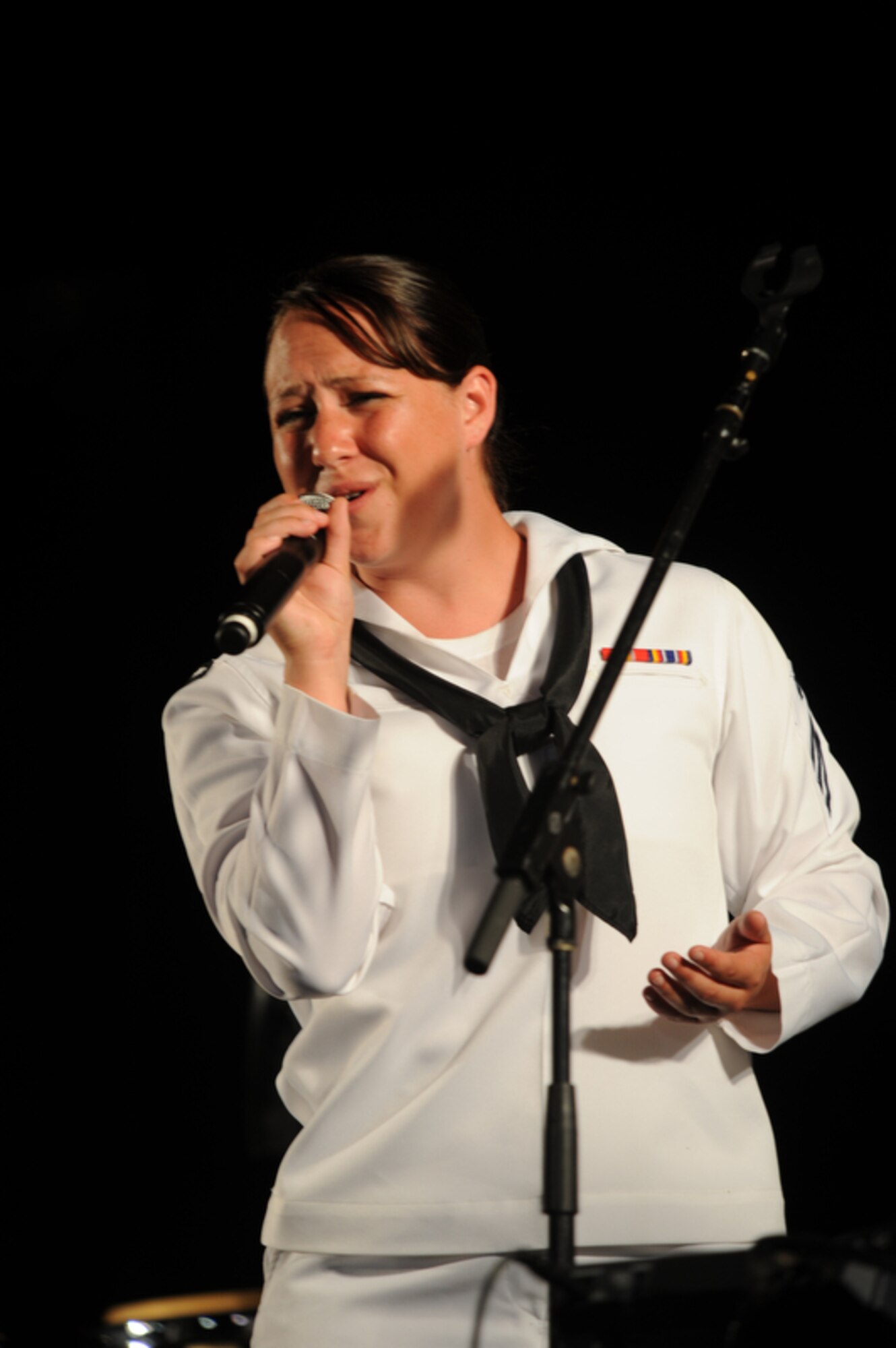 HONOLULU - Seaman Kayla Oleary, a vocalist with the Pacific Fleet Rock Band performs in front of more than 400 onlookers during a Military Band Melee event at Ft DeRussy Park in Honolulu, Hawaii on May 29 as part of Military Appreciation Month and a prelude to Memorial Day events. The Marine Corps Forces Pacific Band, the 25th Infantry Division Band and the U.S. Air Force of the Band of the Pacific-Hawaii also performed. (U.S.  Air Force photo/Tech Sgt. Cohen A. Young)
