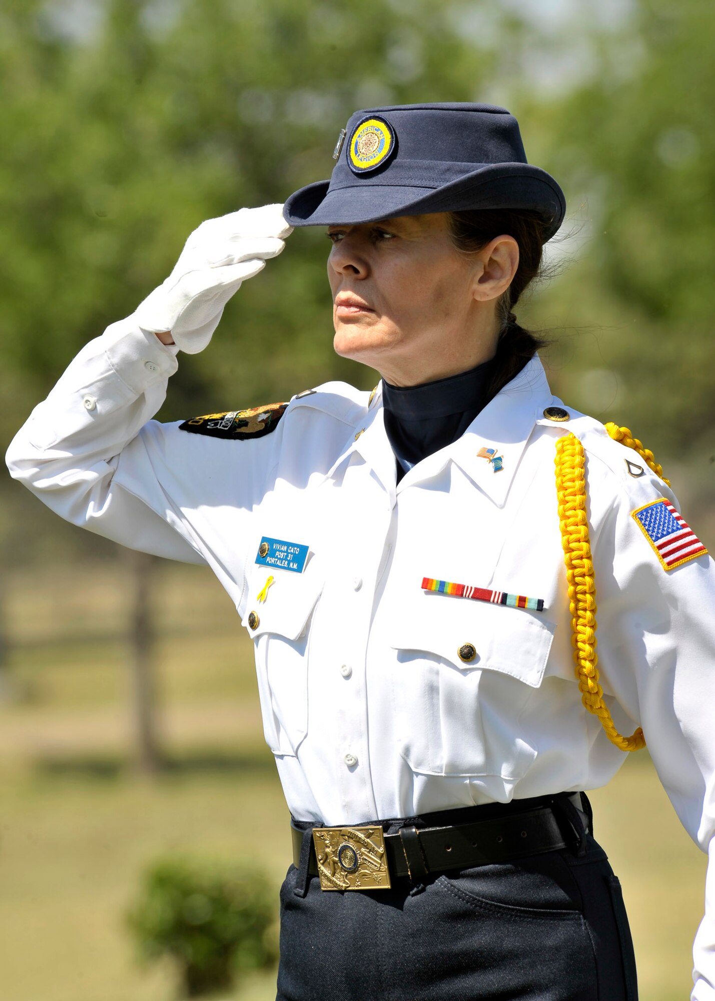 Vivian Cato, American Legion Post #31, renders a salute during the raising of the flag at the 64th Annual American Legion Memorial Day Ceremony, May 31.  The flag was raised to half staff in remembrance of those who have lost their lives while serving in war.  (U.S. Air Force photo by Staff Sgt. Heather R. Redman)
