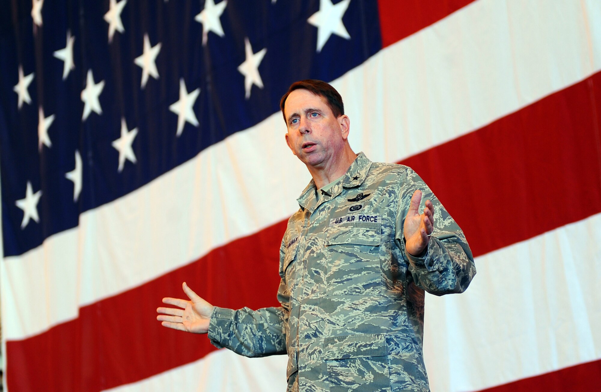 OFFUTT AIR FORCE BASE, Neb. -- Brig. Gen. John N.T. Shanahan, 55th Wing commander, gives a safety briefing to several hundred members of Team Offutt inside Dock One of the Bennie Davis Maintenance Facility here May 27.  The briefing kicked off the base's Critical Days of Summer Safety Campaign, as well as the Offutt's annual Safety Day. U.S. Air Force Photo by Josh Plueger