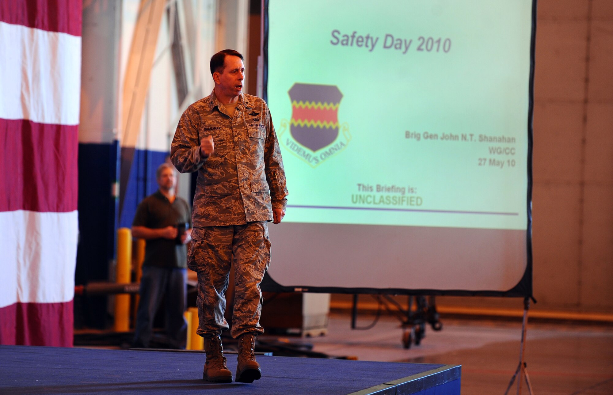 OFFUTT AIR FORCE BASE, Neb. -- Brig. Gen. John N.T. Shanahan, 55th Wing commander, gives a safety briefing to several hundred members of Team Offutt inside Dock One of the Bennie Davis Maintenance Facility here May 27.  The briefing kicked off the base's Critical Days of Summer Safety Campaign, as well as the Offutt's annual Safety Day. U.S. Air Force Photo by Josh Plueger