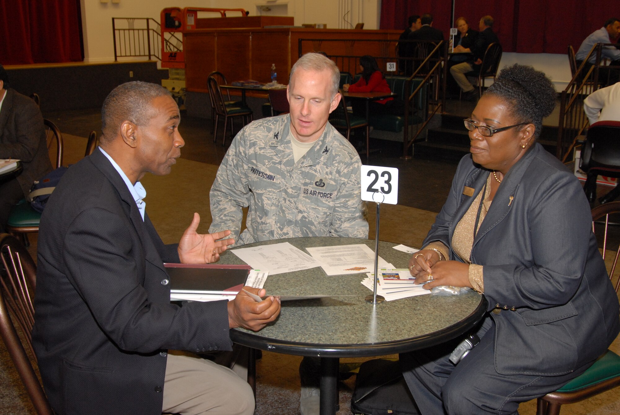 Jean Claude Brunache (left), a vendor looking to do business on Edwards, meets with Col. Wayne Patterson, 95th Contracting Directorate director, and Donna L. Thomason, director, Small Business Programs Office.  "The Path to Desert Oppurtunities"  was the title of the Annual Small Business Seminar, May 26 and 27.  About 200 small business owners and representatives met with base organizations to offer their products or services.  (Air Force photo by Kenji Thuloweit) 