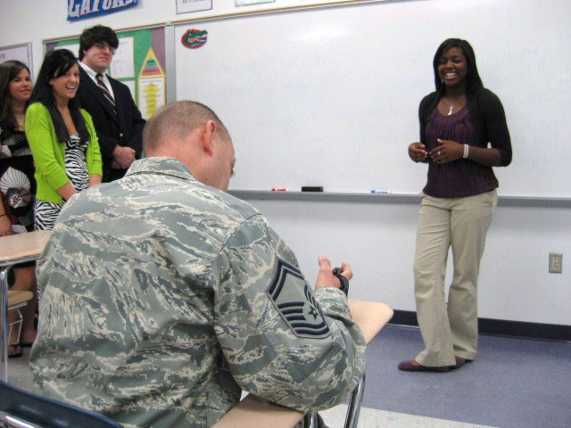 Senior Master Sgt. Jeff Wiliams, 916th Security Forces Squadron, grades a senior presentation at Spring Creek High School. (USAF photo by MSgt. Wendy Lopedote, 916PA)
