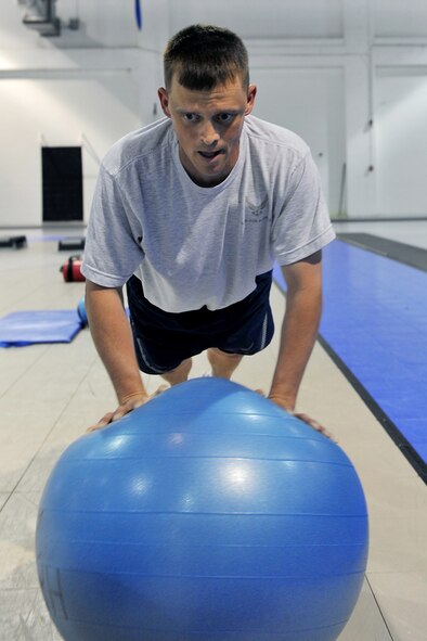 OFFUTT AIR FORCE BASE, Neb. -- Tech. Sgt. Jeffrey Strauser, 55th Maintenance Squadron, performs a push-up on an exercise ball during a Boot Camp class at the Offutt Field House May 19. The Boot Camp class is held every Wednesday and Friday from 3:15 to 4:15 p.m. The class consists of circuit training and a combination of high-intensity aerobics, as well as resistance training designed to target fat loss, build muscle and improve heart health. U.S. Air Force Photo by Charles Haymond