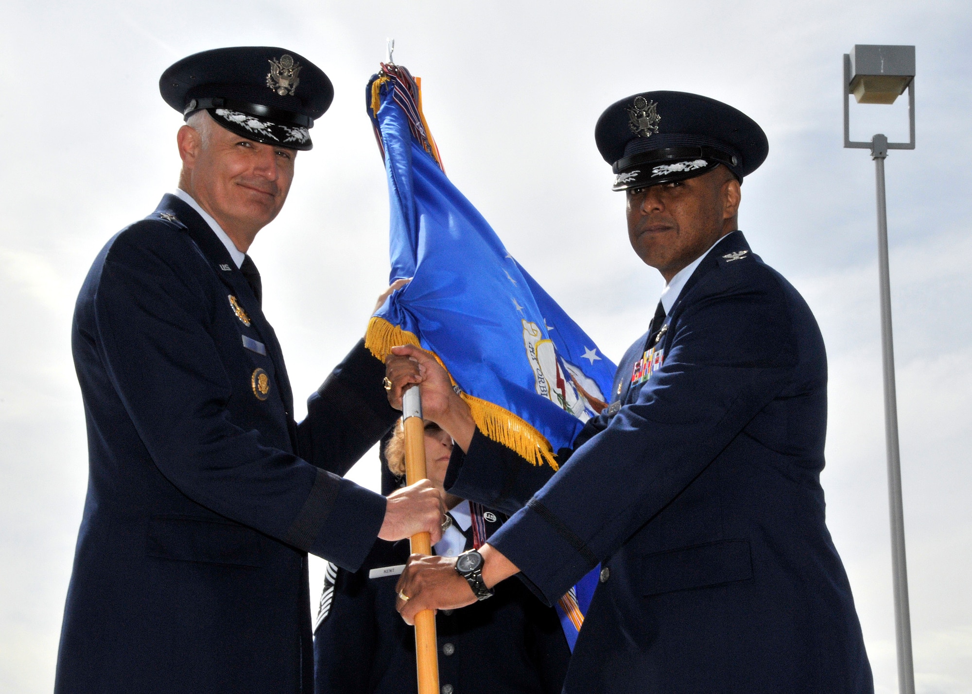 Maj. Gen. Roger Burg, 20th Air Force commander, passes the 341st Missile Wing guidon to Col. Anthony Cotton, the new 341st Missile Wing commander at the change of command ceremony May 26.(U.S. Air Force photo/John Turner)