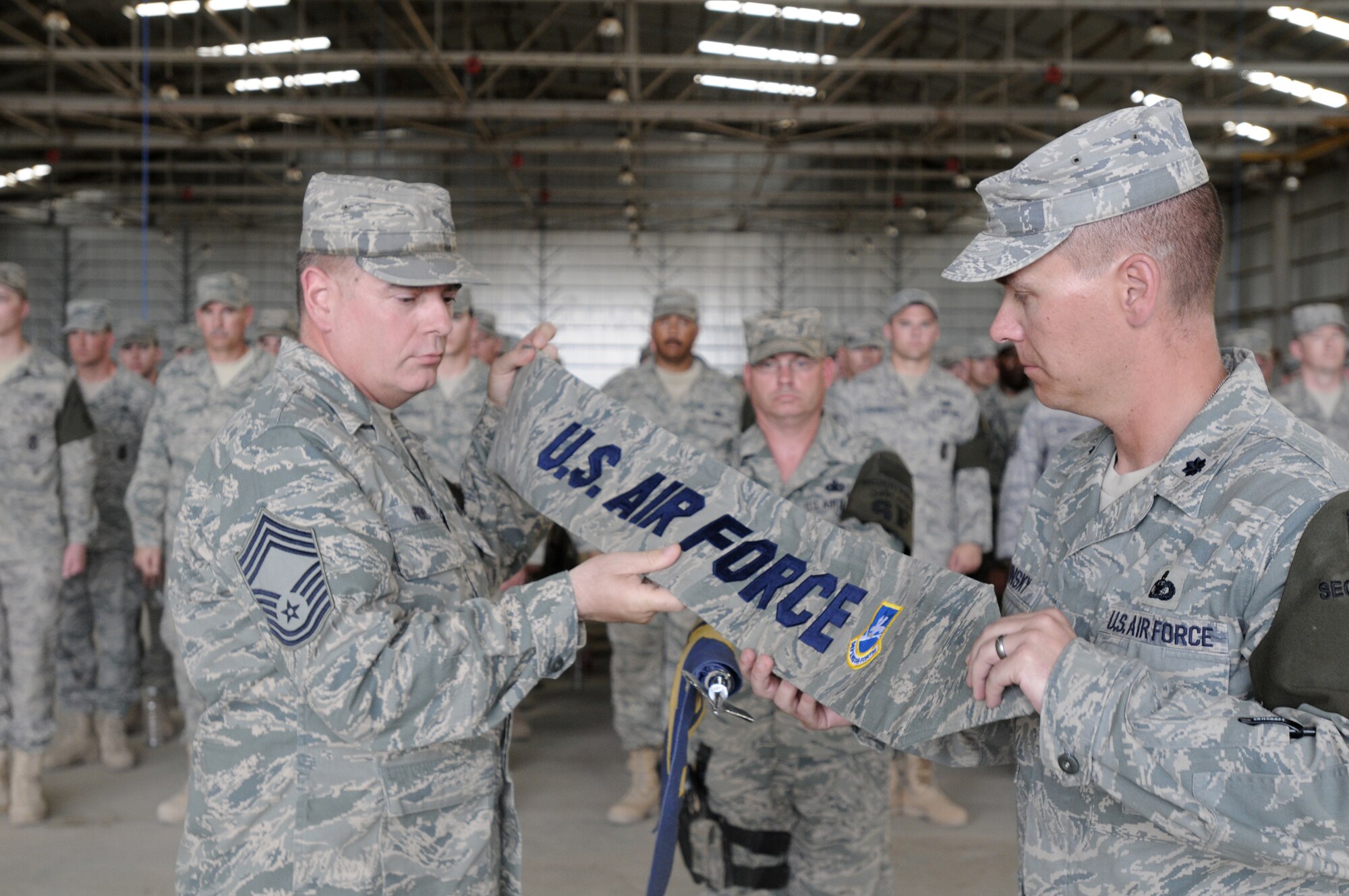 Chief Master Sgt. David Provo and Lt. Col. Theodore Ruminsky case the 506th ESFS squadron guidon for the final time during a transfer of authority ceremony May 28, 2010, at Kirkuk Regional Air Base, Iraq. Members of the 506th ESFS transferred base security to the Army 1st Special Troops Battalion. In addition to the transfer of authority, the 506th ESFS was officially inactivated. Chief Provo is the 506th Expeditionary Security Forces Squadron chief enlisted manager. Colonel Ruminsky is the 506th ESFS commander. (U.S. Air Force photo)
