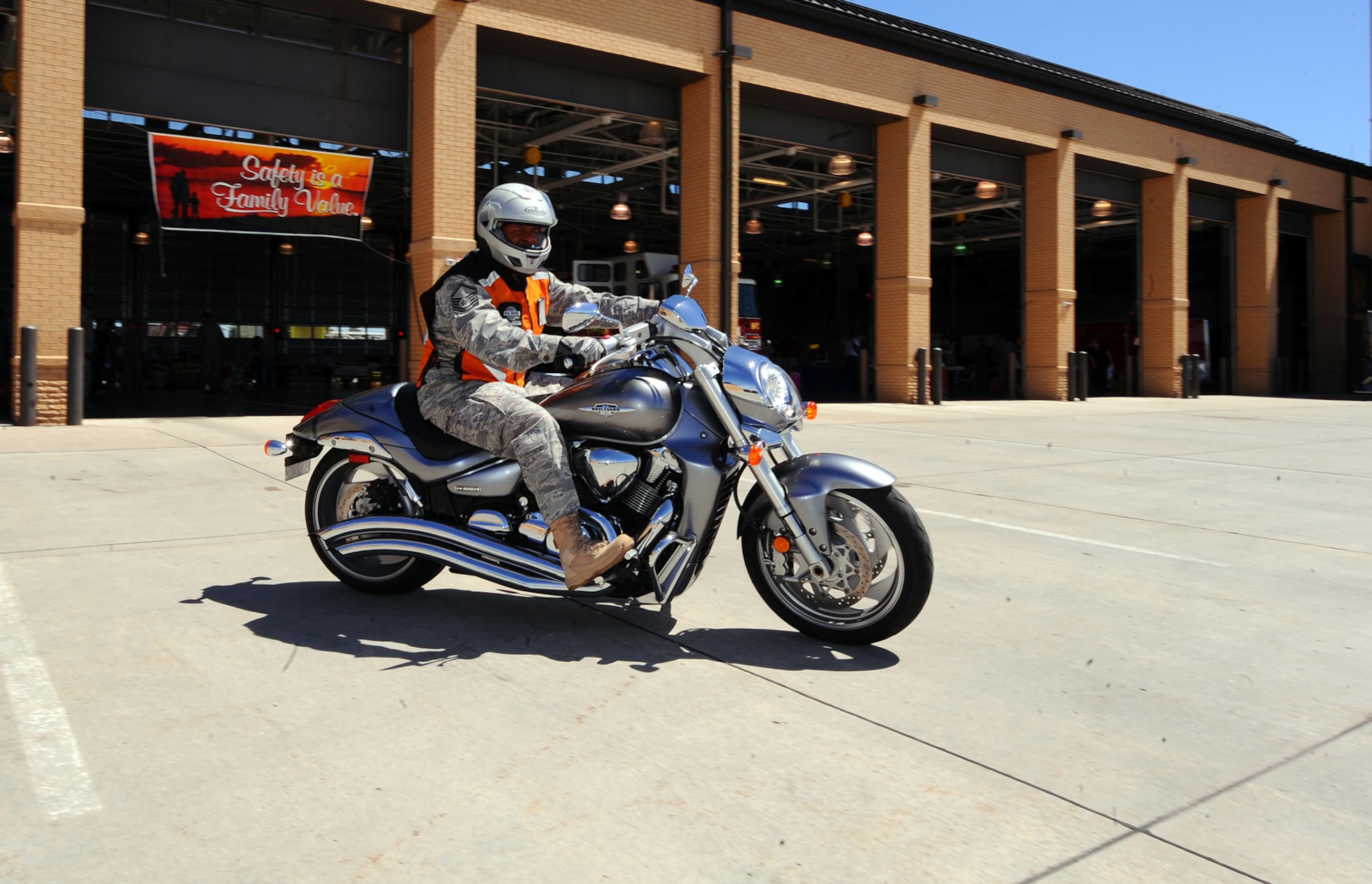 OFFUTT AIR FORCE BASE, Neb. - Master Sgt. Michael Milton, a weather enterprise programs manager with the Air Force Weather Agency, drives away from the Offutt Fire Department May 27 on his Suzuki Boulevard M109 R2 after participating in the Wing Safety Day Information Fair and burger burn. During the event, numerous vendors gave useful information to attendees that focused on staying safe during the summer. U.S. Air Force Photo by Josh Plueger
