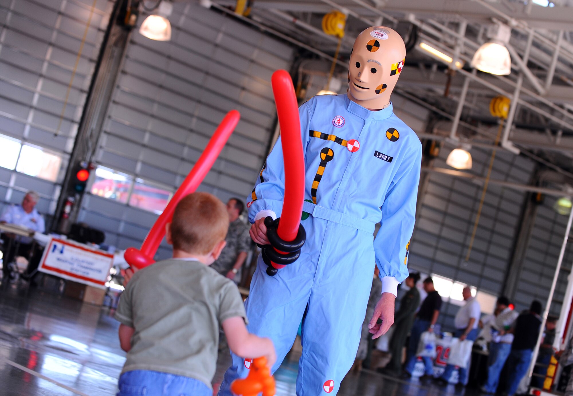 OFFUTT AIR FORCE BASE, Neb. -- Five year old Charlie Hamilton, grandson of Barbara Ronsick with the 520th Software Maintenance Squadron, has a balloon sword fight with crash test dummy Larry as part of Wing Safety Day at the Offutt Fire Department here May 27. During the event, numerous vendors gave useful information to attendees that focused on staying safe during the summer. U.S. Air Force Photo by Josh Plueger
