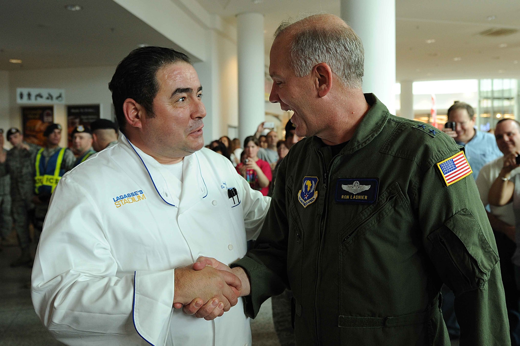 Celebrity Chef Emeril Lagasse greets Maj. Gen. Ronald R. "Ron" Ladnier, 17th Air Force and U.S. Air Forces Africa commander, at the Kaiserslautern Military Community Center, Ramstein Air Base, Germany, May 29, 2010. Celebrity Chef Emeril Lagasse visited military family members at the KMCC by signing copies of his new book and performing an hour long cooking demonstration for over a thousand visitors. (U.S. Air Force photo by Staff Sgt. Stephen J. Otero)