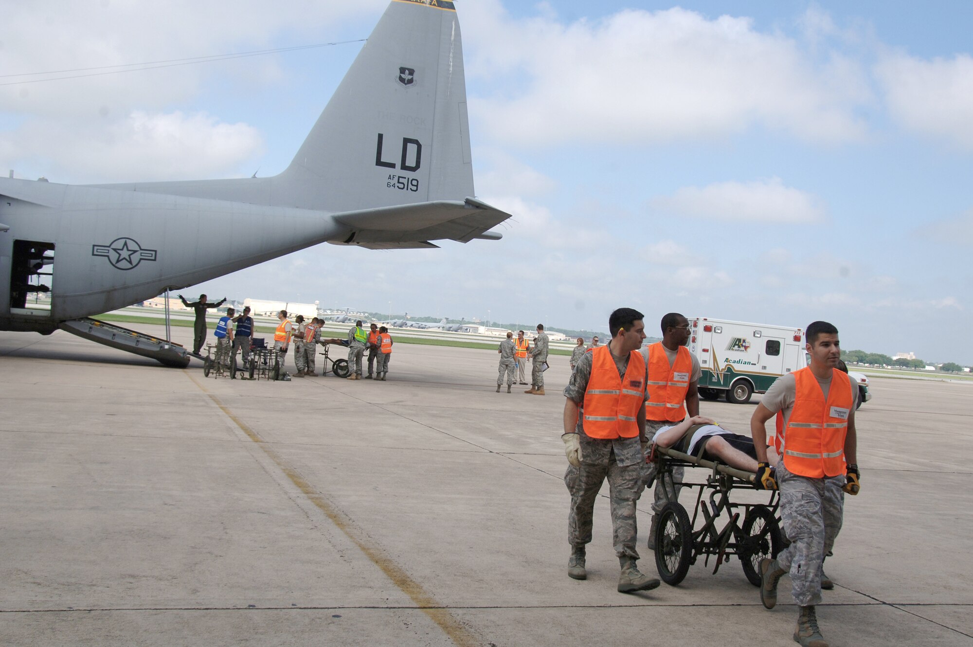 Members of the 59th Medical Wing manpower team transport an exercise patient to be triaged during a National Disaster Medical System exercise May 27, 2010, at Port San Antonio, Texas. Forty volunteers simulated injured patients who had received medical stabilization en route to Port San Antonio and then were transported to area hospitals according to injury and availability of bed spaces. (U.S. Air Force photo/Senior Airman Nicole Mickle)