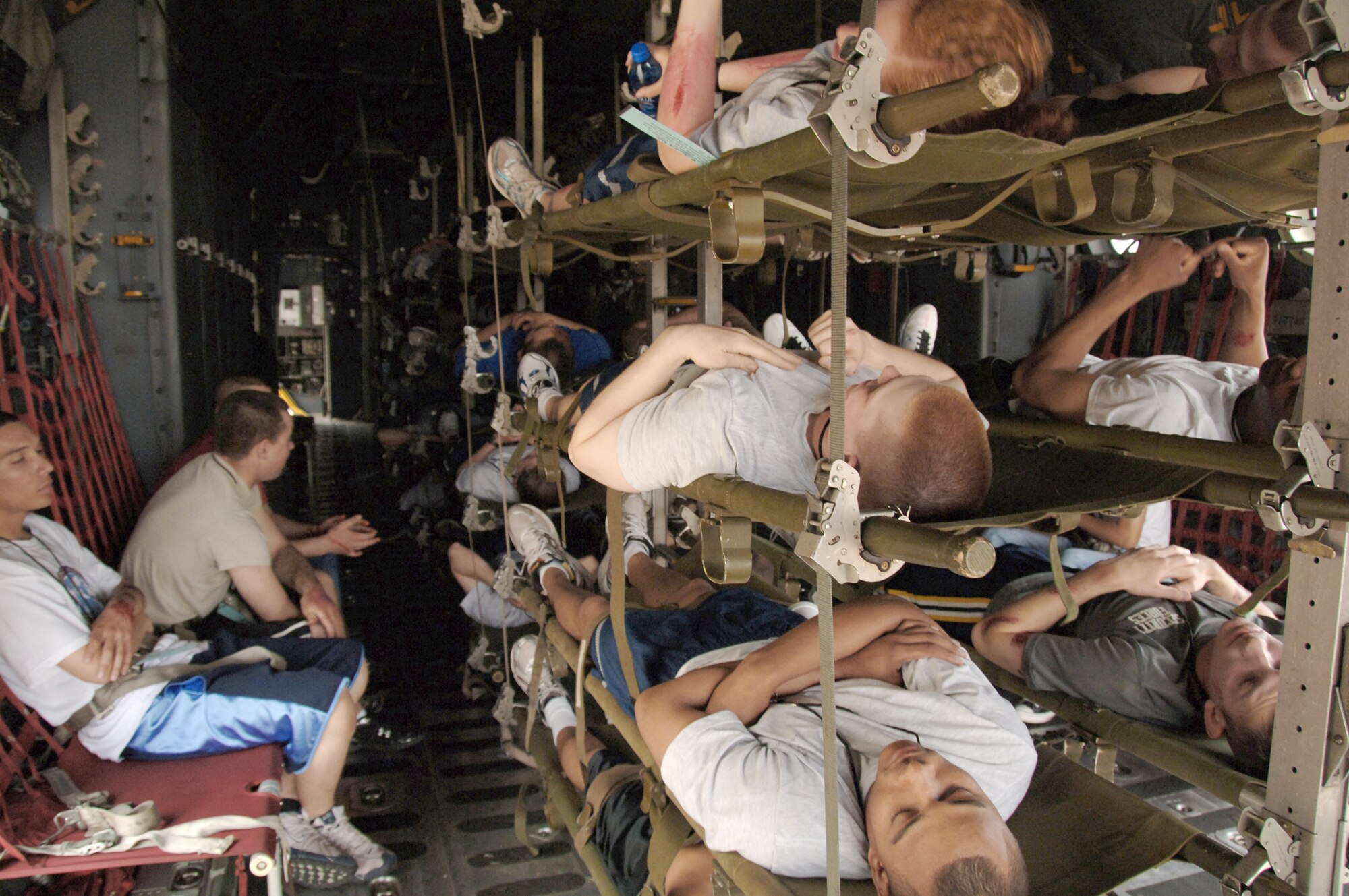 Exercise victims wait to be transported out of the C-130 Hercules by members of the 59th Medical Wing manpower team during a National Disaster Medical System exercise May 27, 2010, at Port San Antonio, Texas. The NDMS exercise had 250 participants, including 9 ambulances and 40 patients from various military and civilian agencies in San Antonio. (U.S. Air Force photo/Senior Airman Nicole Mickle)