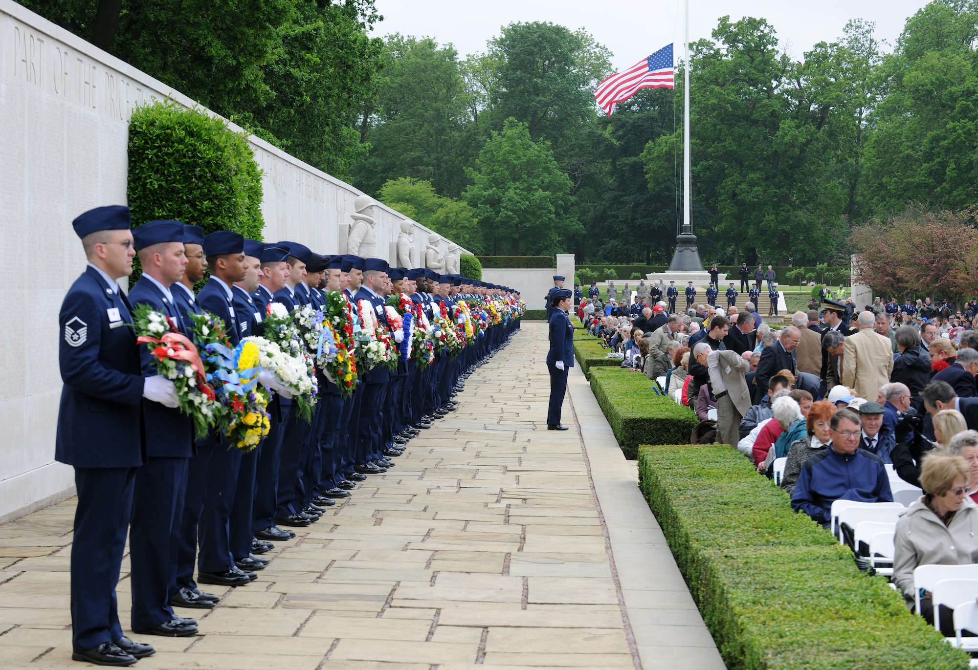 RAF MILDENHALL, England – Dozens of Airmen carry wreaths donated from various organizations to lay at the Wall of the Missing as part of the Memorial Day event at Madingley Memorial Cemetery May 31.  The event is held annually and includes full military honors to remember all our fallen heros. (U.S. Air Force photo/ Staff Sgt. Jerry Fleshman)