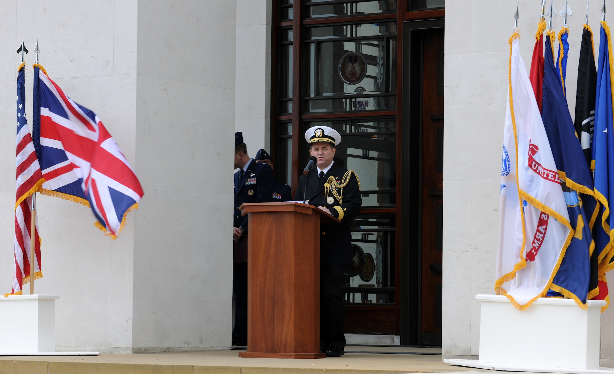 RAF MILDENHALL, England – Rear Admiral Ronald Henderson, U.S. Defense Attache, United Kingdom, gave welcoming remarks to an audience during the Memorial Day ceremony at Madingley Memorial Cemetery May 31.  The event included a wreath laying, fly-overs and a 21-gun salute. (U.S. Air Force photo/ Staff Sgt. Jerry Fleshman)