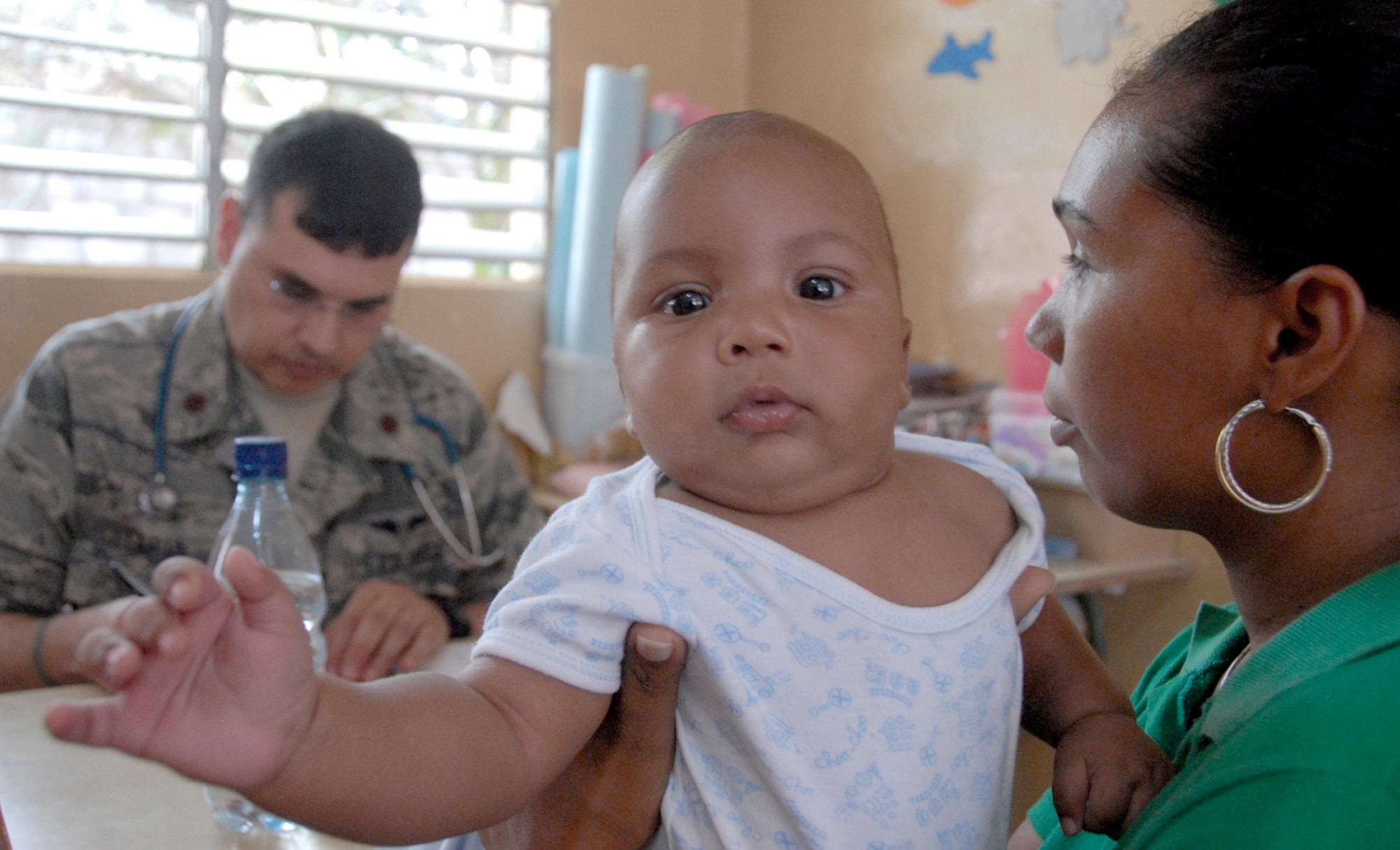 Maj. (Dr.) Javier Tapia checks a Dominican baby during a medical readiness exercise May 24, 2010, in the Dominican Republic. A team of 39 medical specialists from Air Force Reserve Command is providing medical care to four towns in the Puerto Plata region of the country. Doctor Tapia is a physician with the 908th Aeromedical Staging Squadron at Maxwell Air Force Base, Ala. (U.S. Air Force photo/Master Sgt. Chance C. Babin)