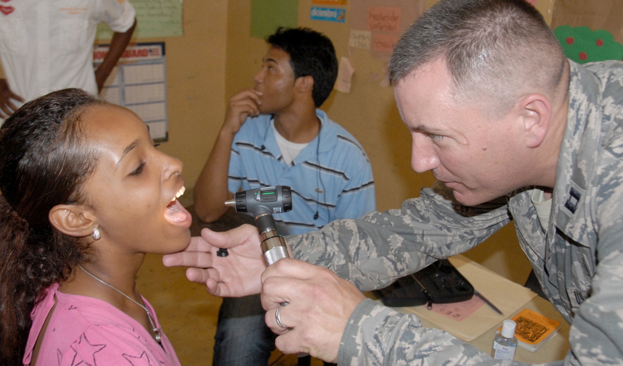 Capt. Craig Romero checks a Dominican patient during a medical readiness exercise May 24, 2010, in the Dominican Republic. A team of 39 medical specialists from Air Force Reserve Command is providing medical care to four towns in the Puerto Plata region of the country. Captain Romero is a physician's assistant with the 927th Aeromedical Staging Squadron, MacDill Air Force Base, Fla. (U.S. Air Force photo/Master Sgt. Chance C. Babin)