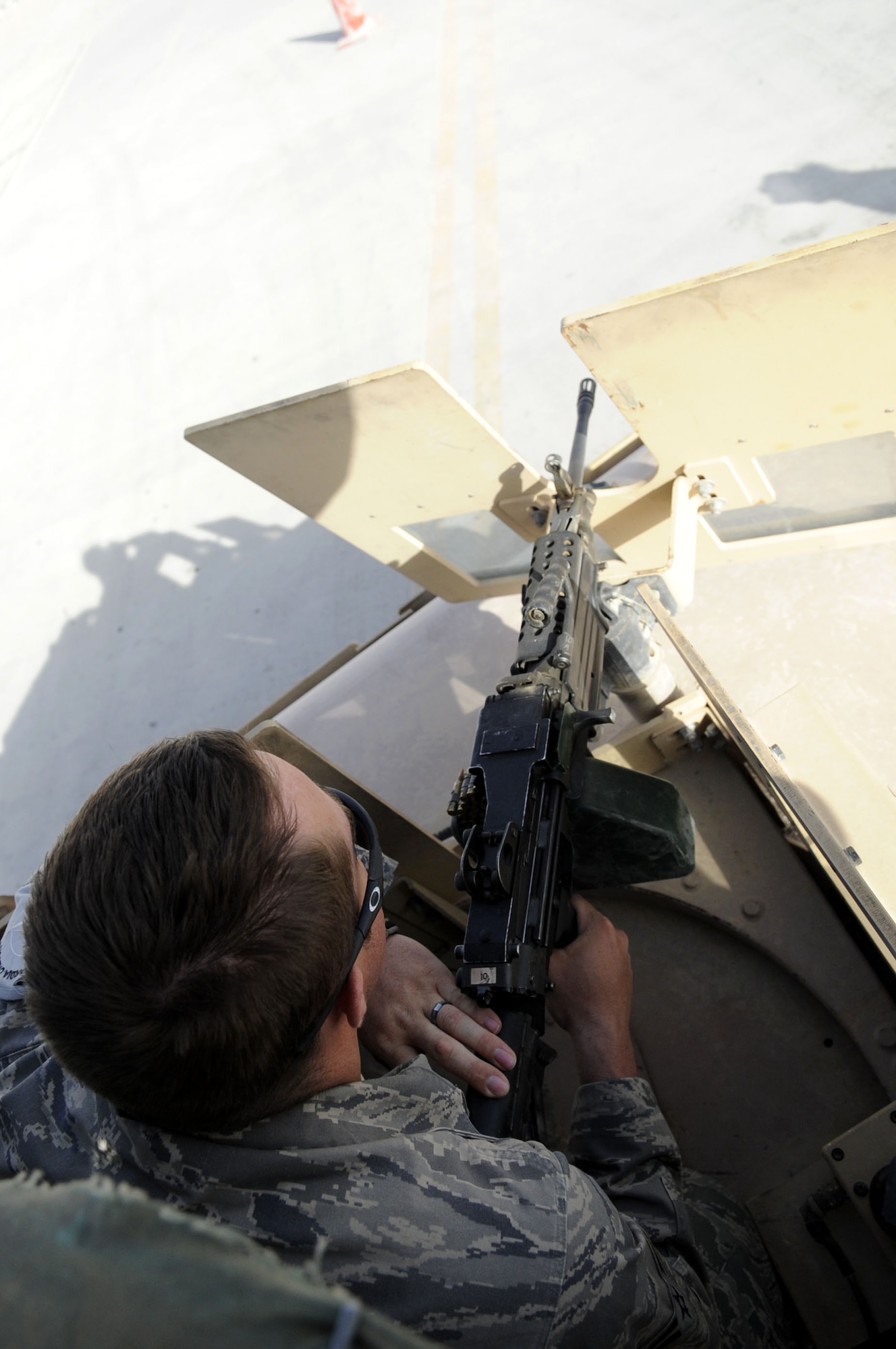 Airman 1st Class Ragan Sheedy, 451st Expeditionary Security Forces Squadron blocking force, controls entry to the flightline in the turet of a HUMVEE May 31 at Kandahar Airfield.  Airman Sheedy is stationed out of Misawa AB, Japan.  (U.S. Air Force photo by Senior Airman Nancy Hooks/Released) 