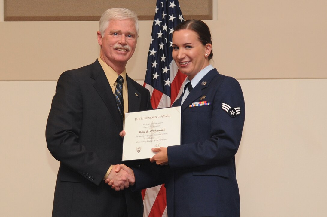 BUCKLEY AIR FORCE BASE, Colo. -- Senior Airman Aleisa Stricharchuk, 566th Intelligence Squadron, receives the William H. Pitsenbarger Award, Airman level, at the Community College of the Air Force Graduation, May 27. The awards are sponsored by the Air Force Association and are competitively awarded to CCAF graduates. (U.S. Air Force photo by Airman 1st Class Manisha Vasquez) 