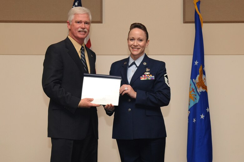 BUCKLEY AIR FORCE BASE, Colo. -- Master Sgt. Lisamichelle Hughes-Belt, Air Reserve Personnel Center, is awarded the William H. Pitsenbarger Award, Senior NCO level, at the Community College of the Air Force Graduation, May 27. The Pitsenbarger award is earned by CCAF graduates who are continuing their education by working towards a Bachelor's Degree by the Air Force Association. (U.S. Air Force Photo by Airman 1st Class Manisha Vasquez) 