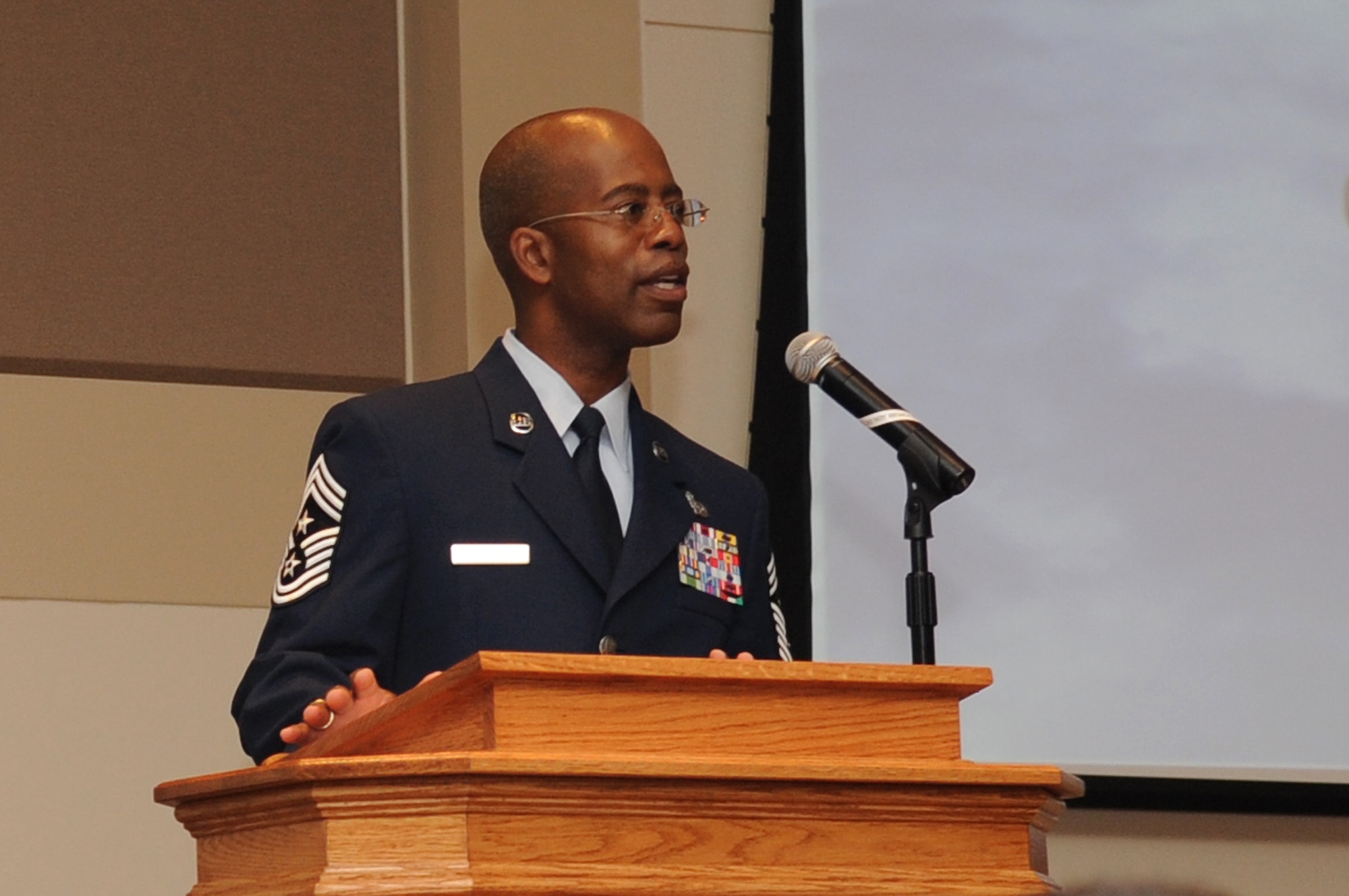 BUCKLEY AIR FORCE BASE, Colo. -- Chief Master Sgt. Robert Ellis, 460th Space Wing command chief, speaks to graduates at the Community College of the Air Force graduation May 27. (U.S. Air Force Photo by Airman 1st Class Manisha Vasquez)