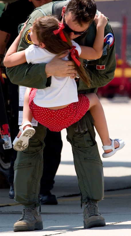 LANGLEY AIR FORCE BASE, Va. – Sarah Warner jumps onto her father, Lt. Col. Clint “Dean” Warner, 71st  Fighter Squadron pilot, upon his return from a two-week temporary duty assignment to Tyndall Air Force Base, Fla., in support of a weapon system evaluation program May 27. The TDY was the last ever for the 71 FS as the unit will be deactivated this fall. The program is designed to evaluate pilots, aircraft and maintenance personnel in the area of ordnance employment. “Our maintenance support was the best I've ever seen in my 17 years of service,” said Lt. Col. Joel Cook, 71 FS commander. (U.S. Air Force photo/Staff Sgt. Barry Loo)