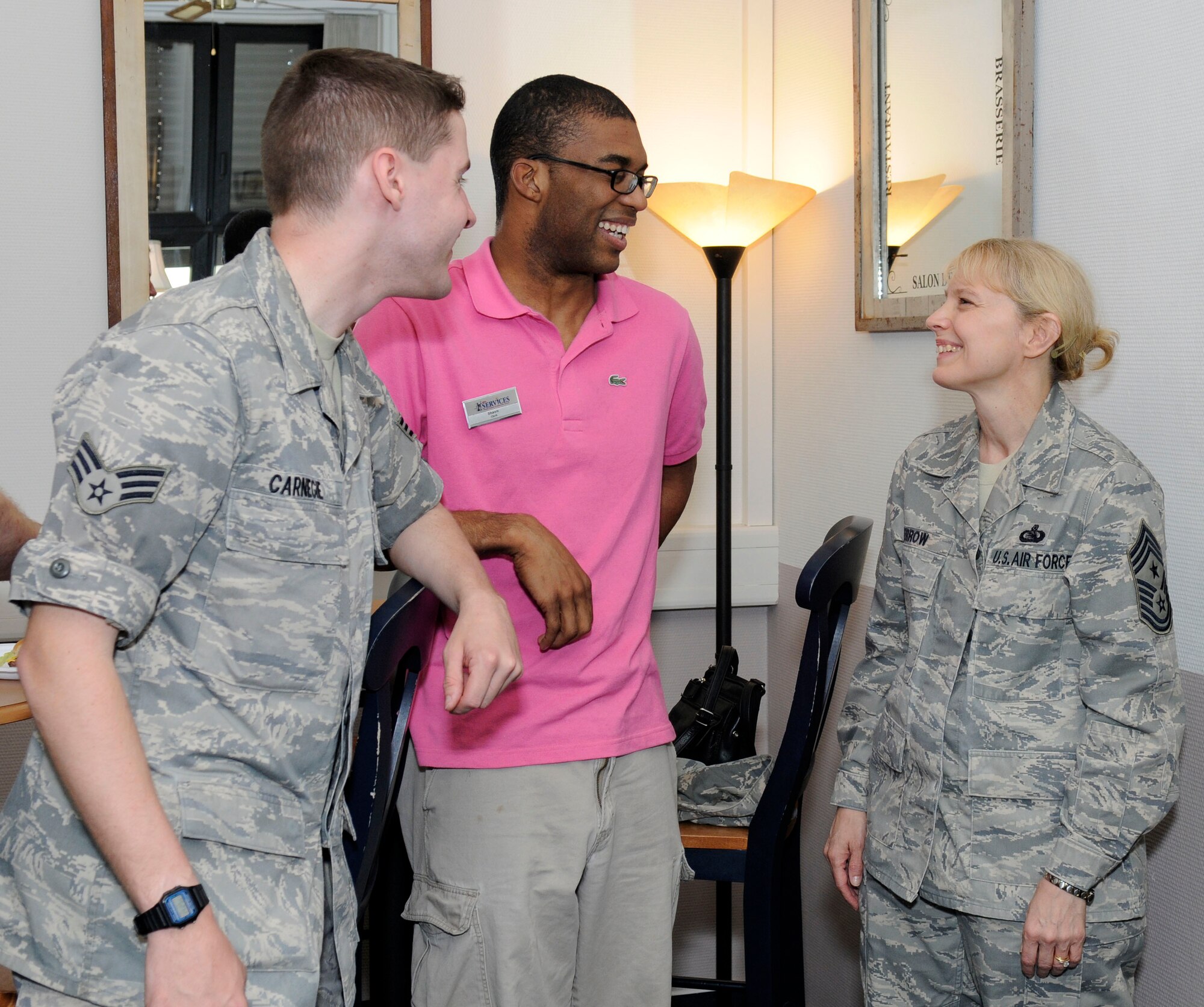 U.S. Air Force Chief Master Sgt. Pamela Derrow, USAFE command chief, chats with Senior Airman Kyle Carnegie, 86th Maintenance Squadron and Shawn Scott, 86th Services, during the Club 7 grand opening, Ramstein Air Base, Germany, June 1, 2010. The Chapel established Club 7 due to a new Air Force initiative to provide an effective venue, ministering to the spiritual and physical needs of single Airmen. (U.S. Air Force photo by Airman 1st Class Brittany Perry)