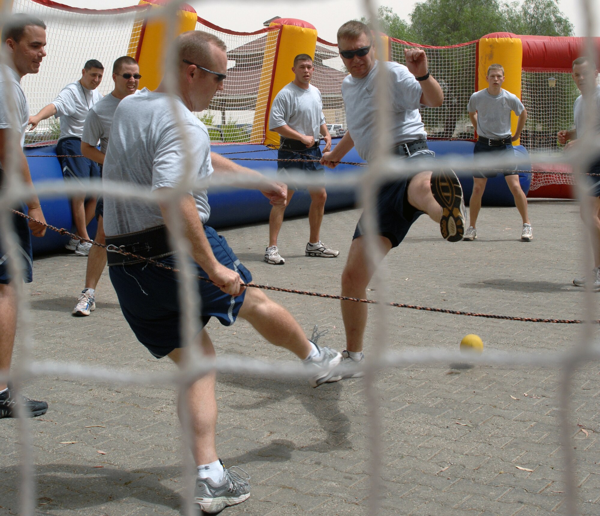 Airmen from the 39th Civil Engineer Squadron and 39th Operation Squadron challenge each other in a game of human foosball during a game of volleyball as part of Wingman Day Friday, May 28, 2010 at Incirlik Air Base, Turkey. Wingman Day is an annual event bringing Airmen together through sports and recreation to focus on what it truly means to be a wingman. As part of Incirlik’s Wingman Day, Airmen from every squadron participated against each other in friendly games of volleyball, human foosball, a human wrecking ball and tricycle racing. (U.S. Air Force photo/Senior Airman Sara Csurilla)