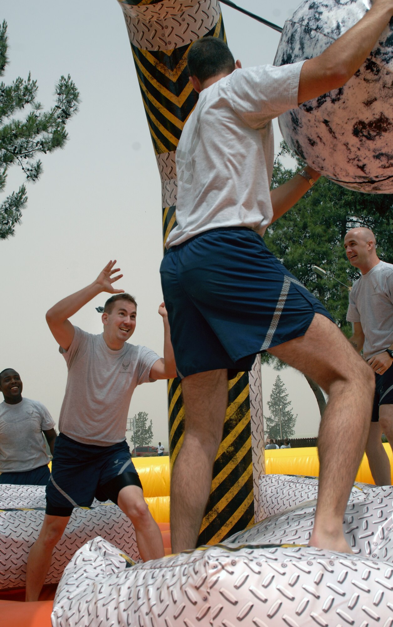Airman 1st Class Christopher Jacobs, Senior Airman John Archiquette and Senior Airman Jonathan Porter, American Forces Network-Incirlik, play human wrecking ball during a game of volleyball as part of Wingman Day Friday, May 28, 2010 at Incirlik Air Base, Turkey. Wingman Day is an annual event bringing Airmen together through sports and recreation to focus on what it truly means to be a wingman. As part of Incirlik’s Wingman Day, Airmen from every squadron participated against each other in friendly games of volleyball, human foosball, a human wrecking ball and tricycle racing. (U.S. Air Force photo/Senior Airman Sara Csurilla)