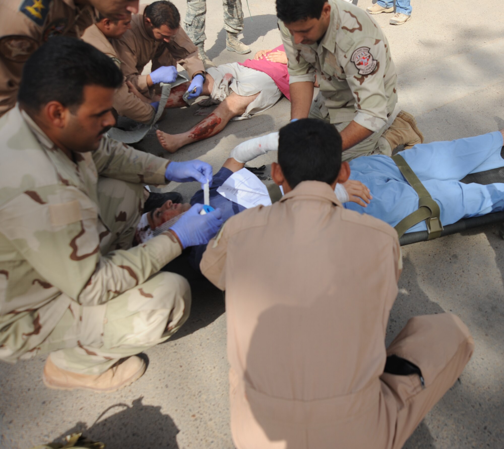Member of the Iraqi military provide medical treatement to a simulated wounded person during an exercise May 20, 2010. Iraqi forces from Al-Muthana, Camp Taji, and New Al-Muthana participated in training that demonstrated their abilities to asses and treat different conditions that may happen in a combat environment