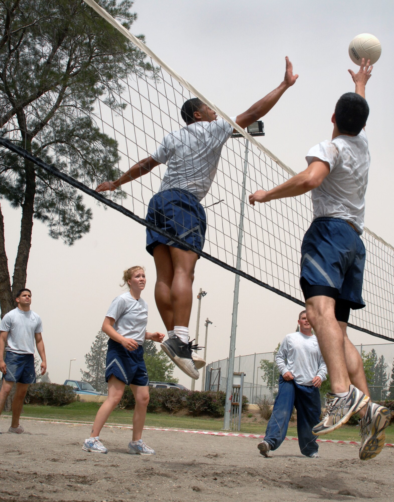 An Airman representing the 39th Communication Squadron attempts to swat the ball during a game of volleyball as part of Wingman Day Friday, May 28, 2010 at Incirlik Air Base, Turkey. Wingman Day is an annual event bringing Airmen together through sports and recreation to focus on what it truly means to be a wingman. As part of Incirlik’s Wingman Day, Airmen from every squadron participated against each other in friendly games of volleyball, human foosball, a human wrecking ball and tricycle racing. (U.S. Air Force photo/Senior Airman Sara Csurilla)