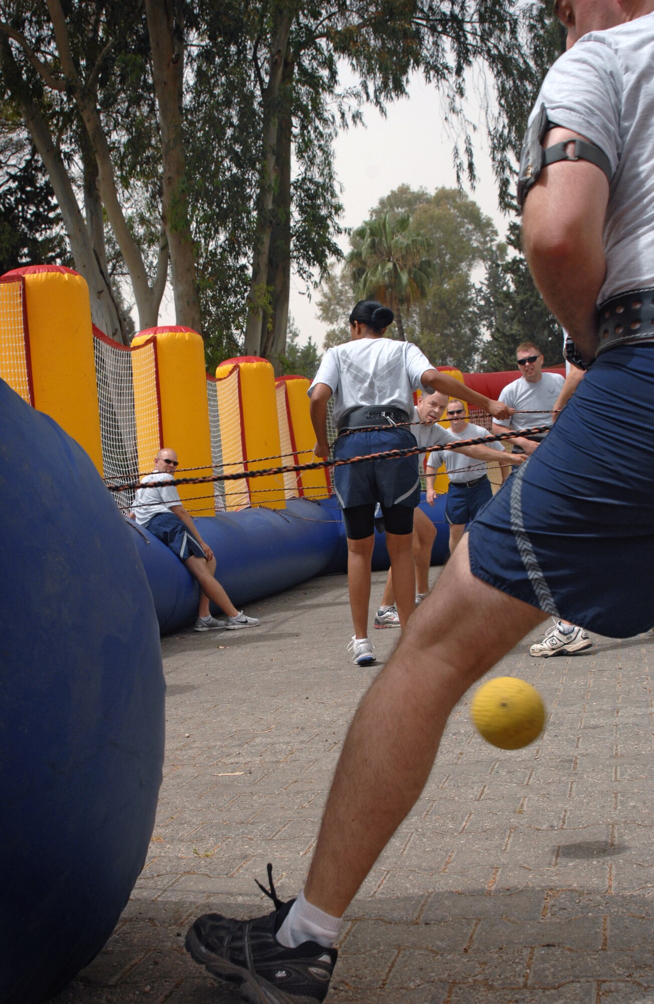 Lt. Col. Stephen Platt, 39th Operations Squadron commander, tries kicking the ball past the goalie of the 39th Civil Engineer Squadron team, during a game of human foosball as part of Wingman Day Friday, May 28, 2010 at Incirlik Air Base, Turkey. Wingman Day is an annual event bringing Airmen together through sports and recreation to focus on what it truly means to be a wingman. As part of Incirlik’s Wingman Day, Airmen from every squadron participated against each other in friendly games of volleyball, human foosball, a human wrecking ball and tricycle racing. (U.S. Air Force photo/Senior Airman Sara Csurilla)