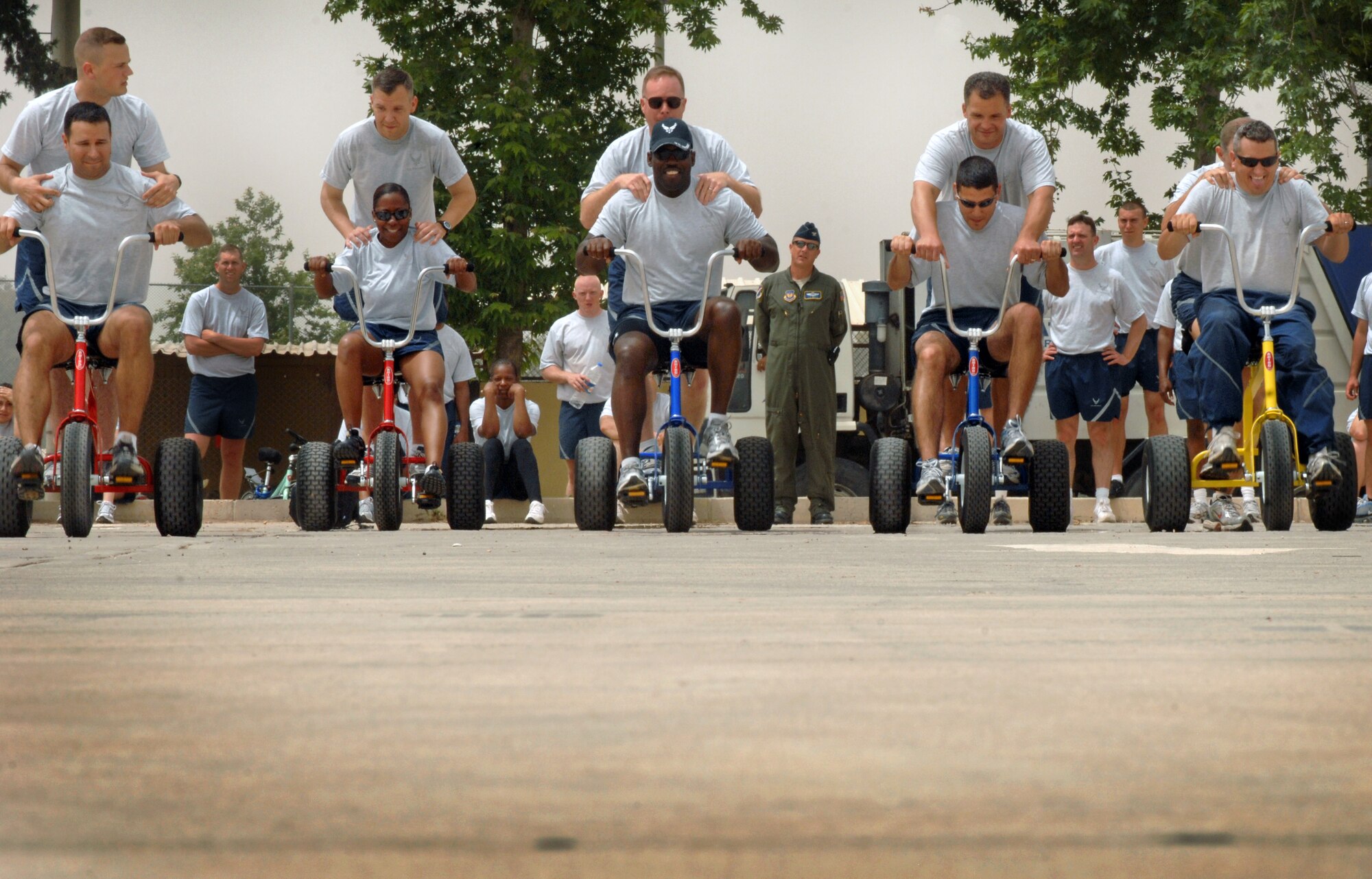 Commanders and their enlisted leader teammate begin a tricycle race as part of Wingman Day Friday, May 28, 2010 at Incirlik Air Base, Turkey. Wingman Day is an annual event bringing Airmen together through sports and recreation to focus on what it truly means to be a wingman. As part of Incirlik’s Wingman Day, Airmen from every squadron participated against each other in friendly games of volleyball, human foosball, a human wrecking ball and tricycle racing. (U.S. Air Force photo/Senior Airman Sara Csurilla)