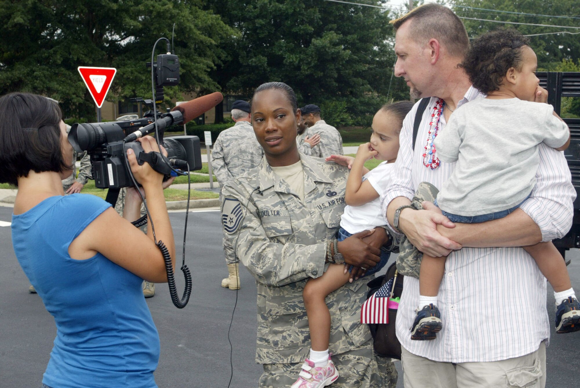 Master Sgt. Engle R. Coulter, 94th Security Forces Squadron, and members of her family speak to local media about her experiences while being deployed overseas. She and twelve fellow security forces team members returned home to family and friends here May 31 after a four month deployment. (U.S. Air Force photo/Don Peek)