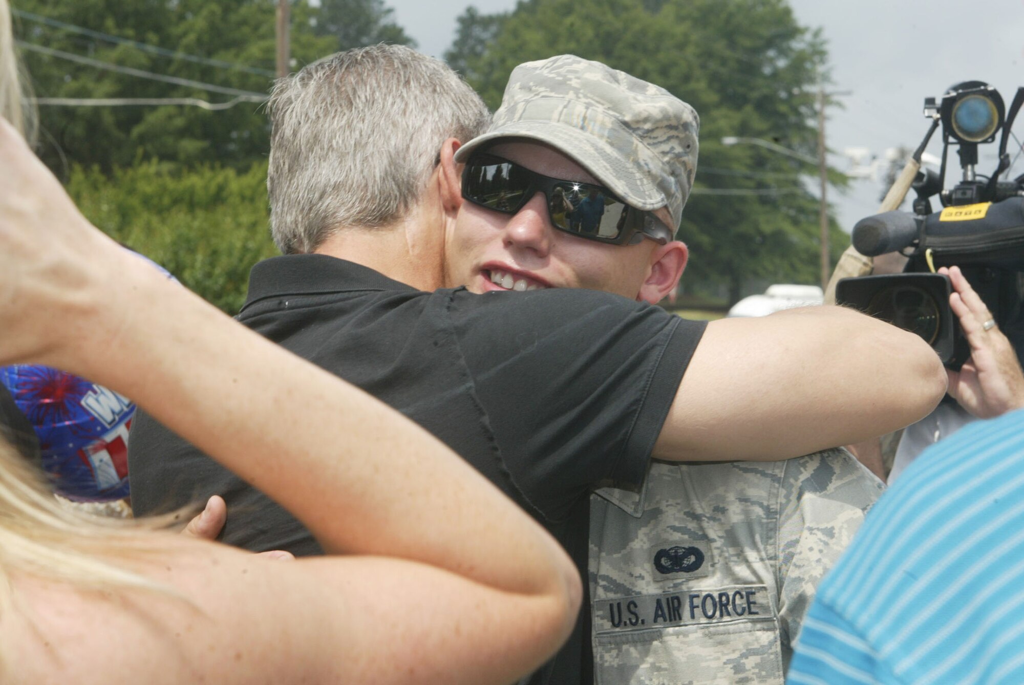 Senior Airman Matthew L. Whaley, 94th Security Forces Squadron receives an emotional welcome home here May 31 from his family as he and twelve other Security Forces members return home from a four month deployment to Iraq. (U.S. Air Force photo/Don Peek)
