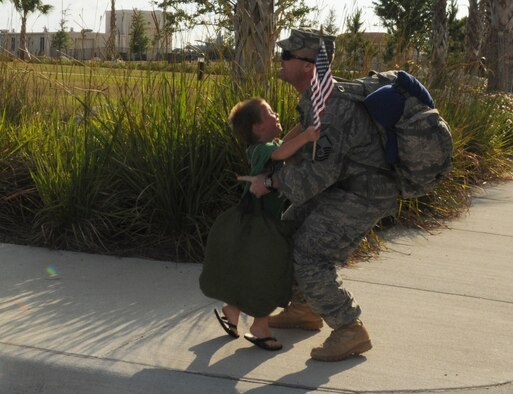 Master Sgt. Scott A. Balderstone of the 927th Security Forces Squadron receives a warm welcome home from his son, Justin, upon returning to MacDill Air Force Base, Fla., after a five-month deployment to Kirkuk Regional Air Base, Iraq, May 30, 2010. (U.S. Air Force photo by Senior Airman Anna-Marie Wyant)