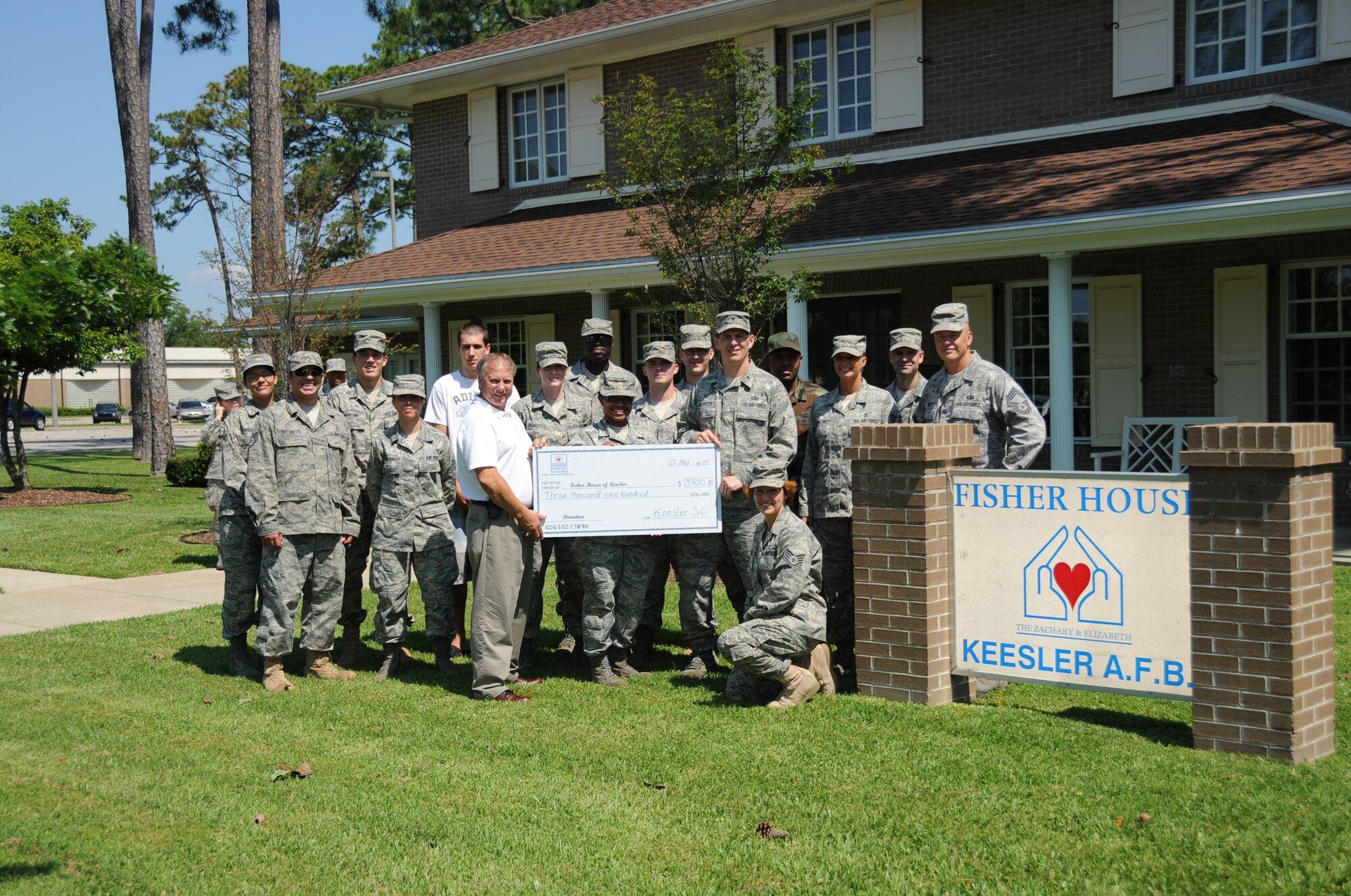Members of Keesler 5/6, accompanied by Brig. Gen. Ian Dickinson, 81st
Training Wing commander, present a check for $3,898.13 to Larry Vetter,
director of Keesler's Fisher House, from its May 8 Dragon Challenge. Sixteen
teams participated in the 12-hour benefit relay marathon.   (U.S. Air Force photo by Kemberly Groue)
