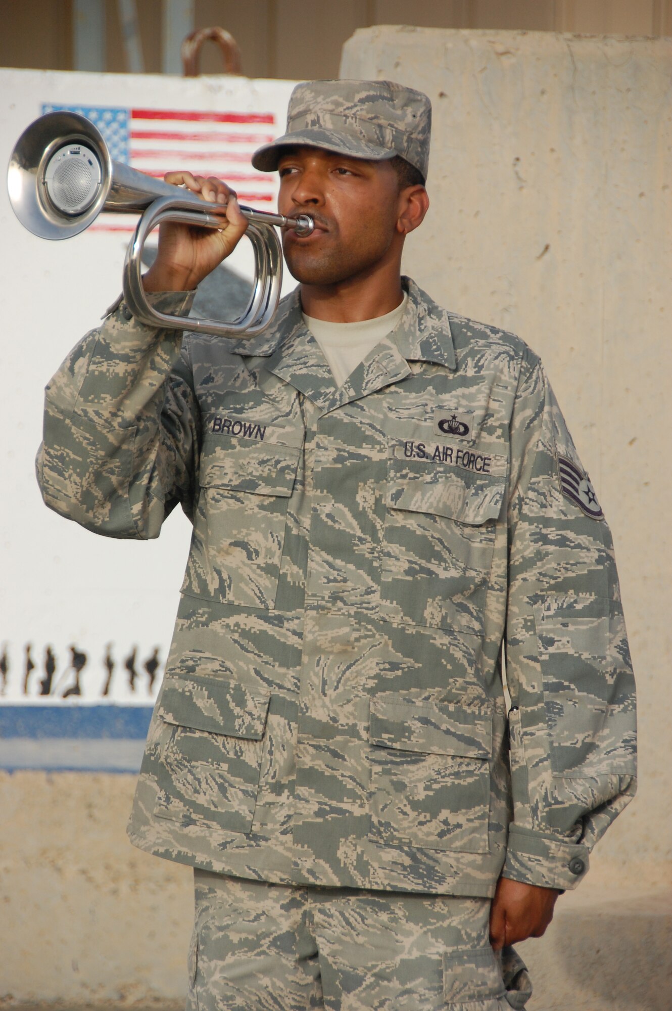SOUTHWEST ASIA - U.S. Air Force Staff Sgt. Cordell Brown, 386th Air Expeditionary Wing Chapel staff, plays "Taps" during a wreath-laying ceremony here May 31, 2010. The Memorial Day ceremony included retreat to retire and pay respect to the flag, and a remembrance ceremony to honor servicemembers who have made the ultimate sacrifice in the defense of the United States. (U.S. Air Force photo by Staff Sgt. Lakisha A. Croley/Released)