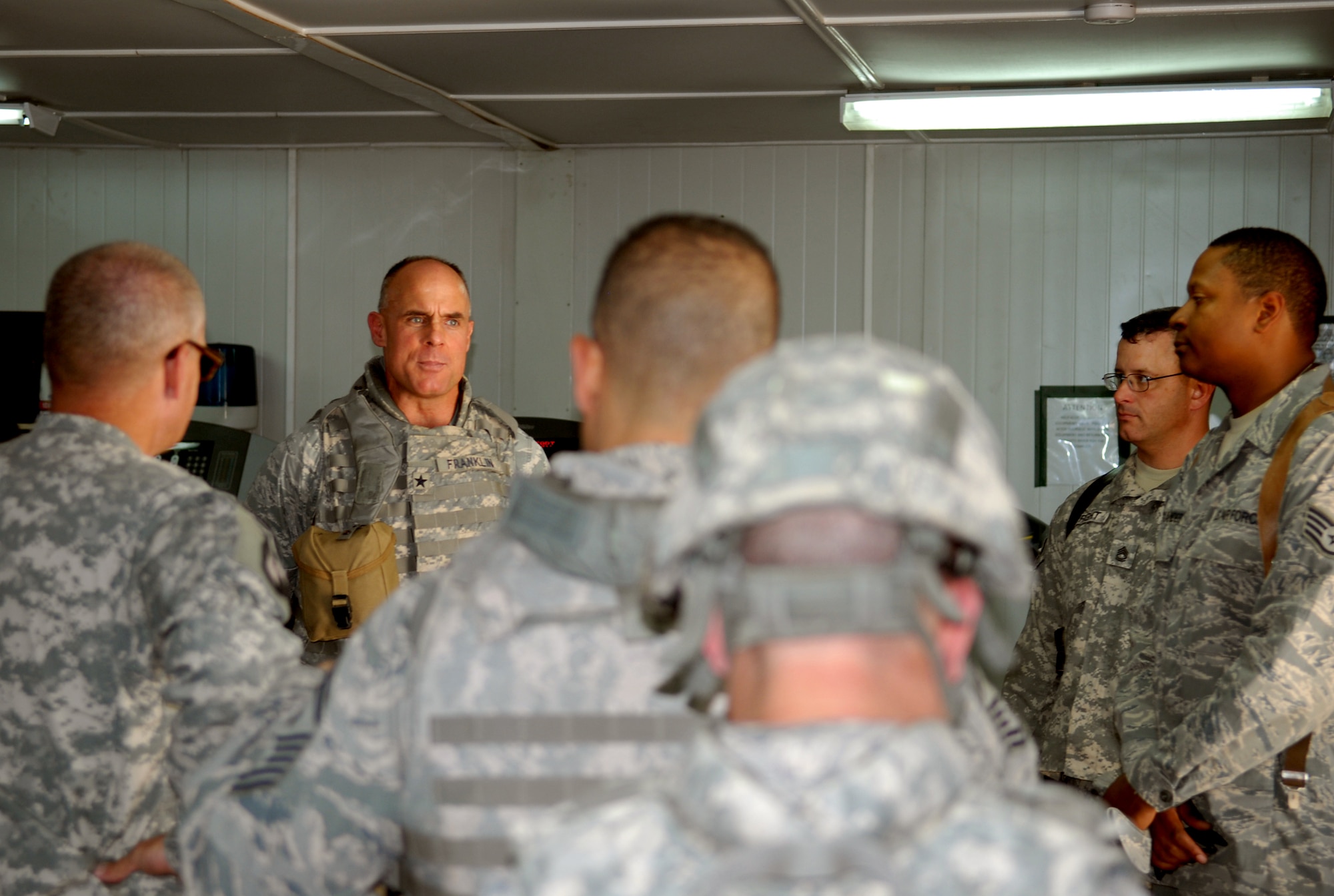 Members of the 732nd Expeditionary Support Squadron Kalsu Provincial Reconstruction Team speak with Brig. Gen. Craig Franklin, 332nd Air Expeditionary Wing commander, about the projects the PRT is taking on as US Forces draw down in Iraq. The PRT team is made up of Joint Expeditionary Tasked Airmen, Army and State Department personnel.(U.S. Air Force photo/ Senior Airman Wes Carter)  